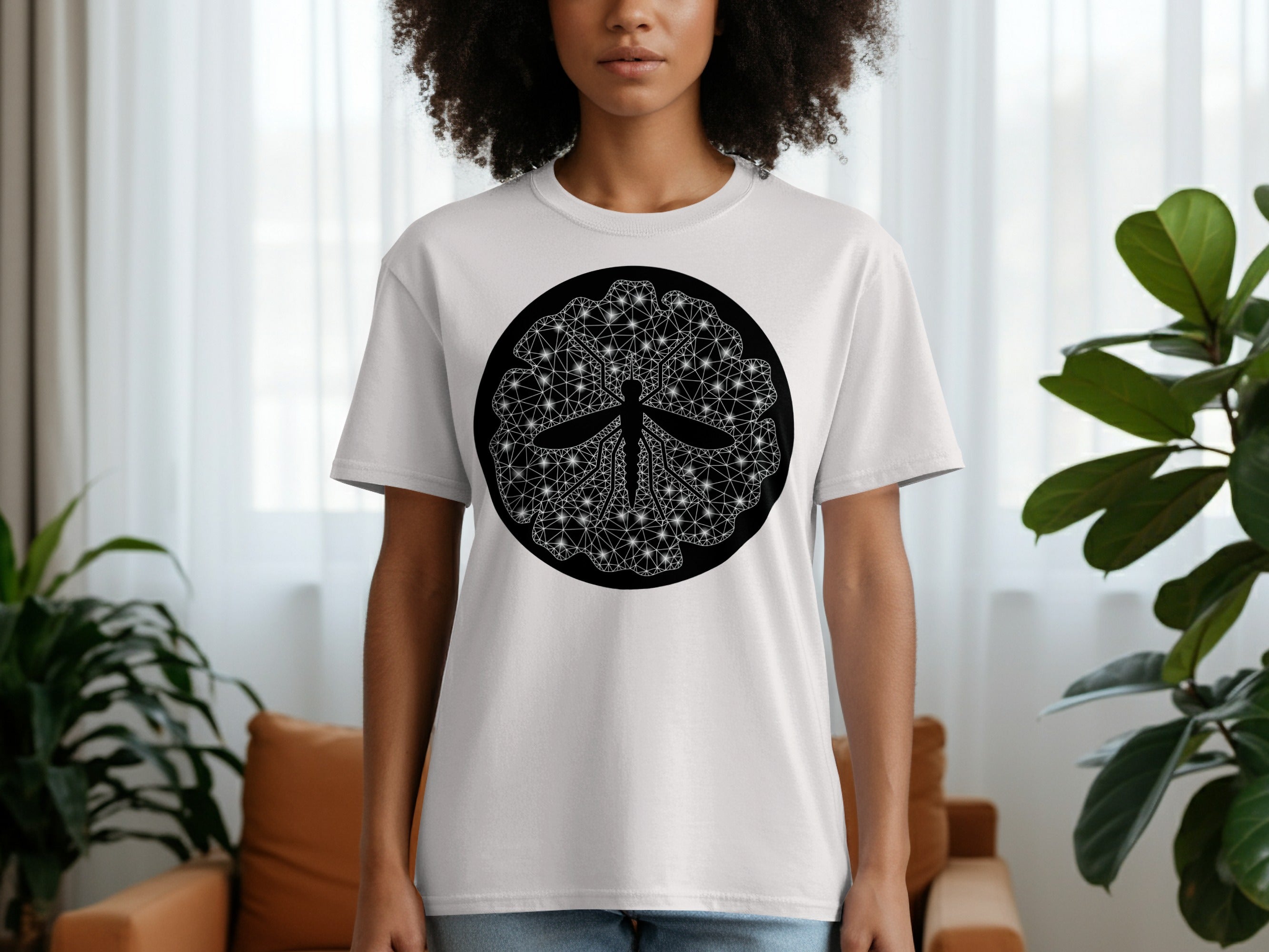 White t-shirt with a black circular graphic featuring a geometric style dragonfly.