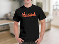 Black t-shirt with orange Halloween graphic featuring spooky elements and dripping text.