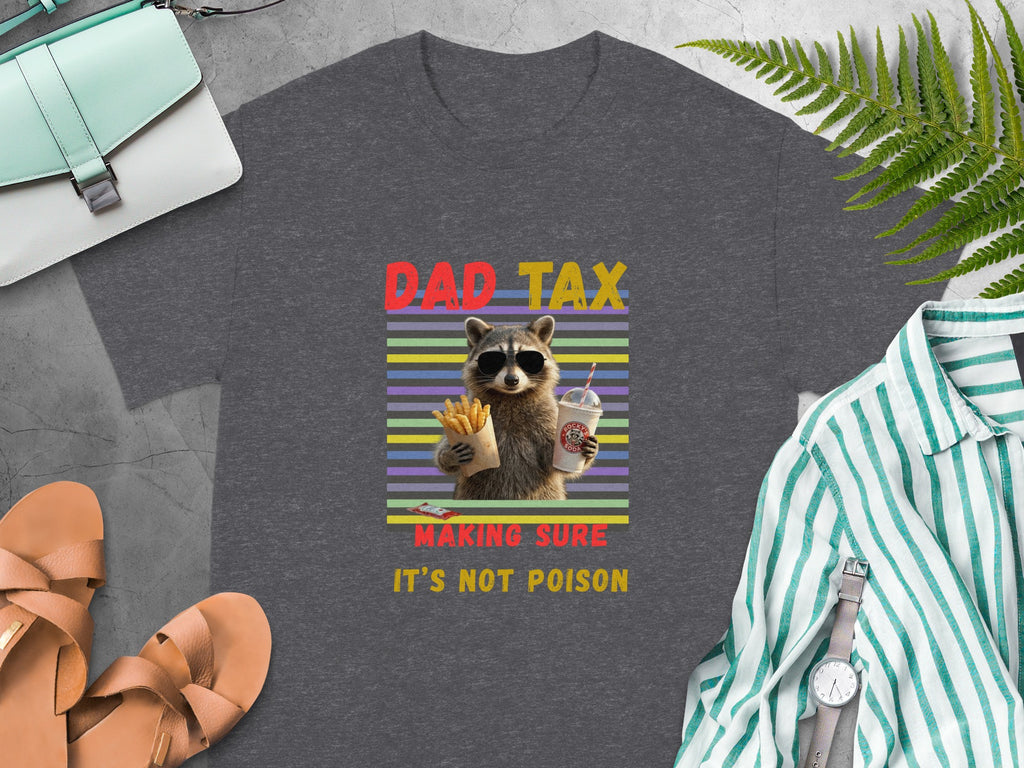 Graphic tee with raccoon holding fries and soda, text reads "DAD TAX MAKING SURE IT'S NOT POISON."