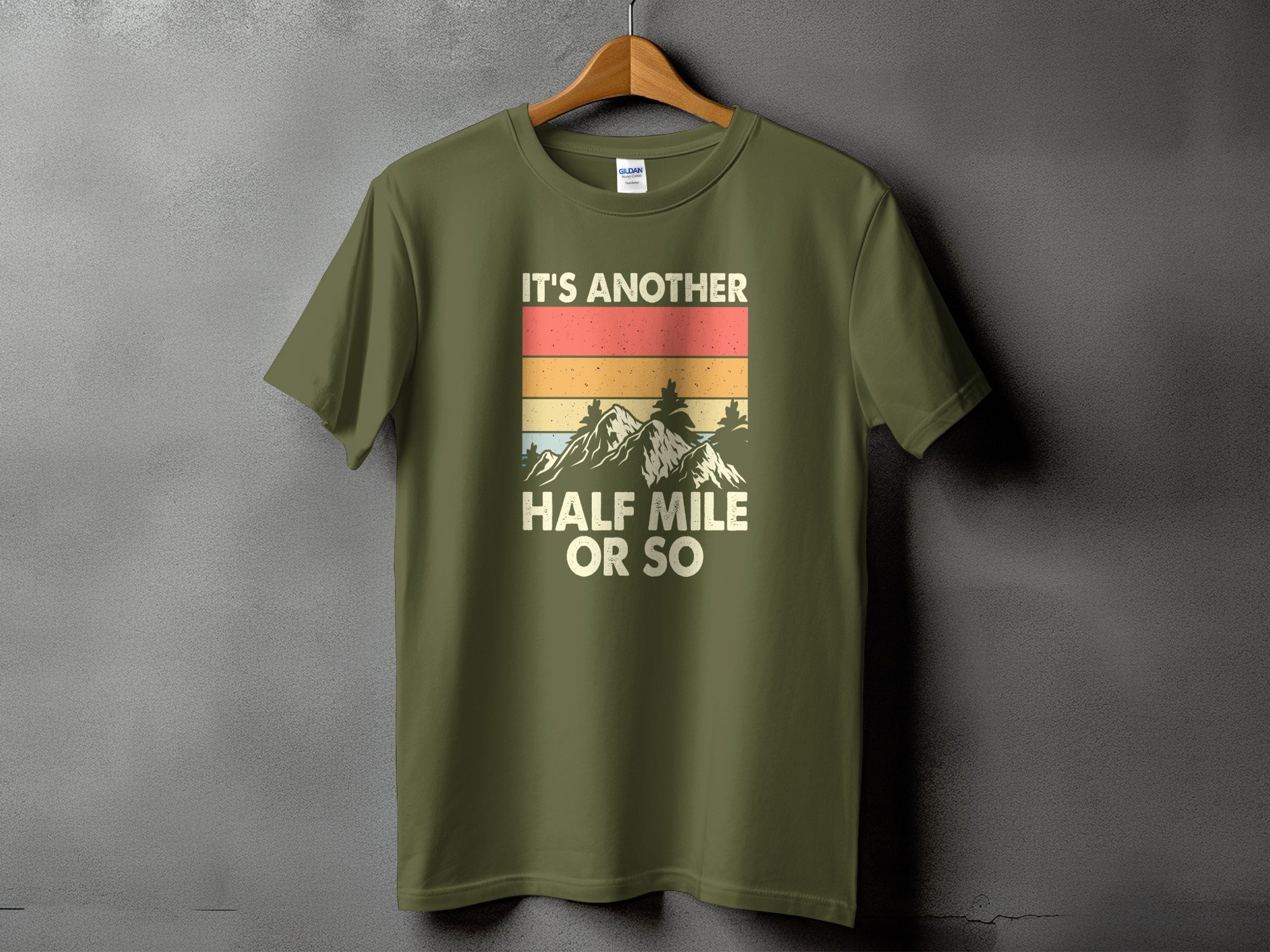 Green t-shirt with vintage mountains and text "It's Another Half Mile Or So".