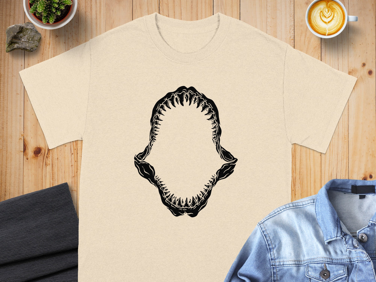 Light tan t-shirt with black shark jaw graphic on chest.