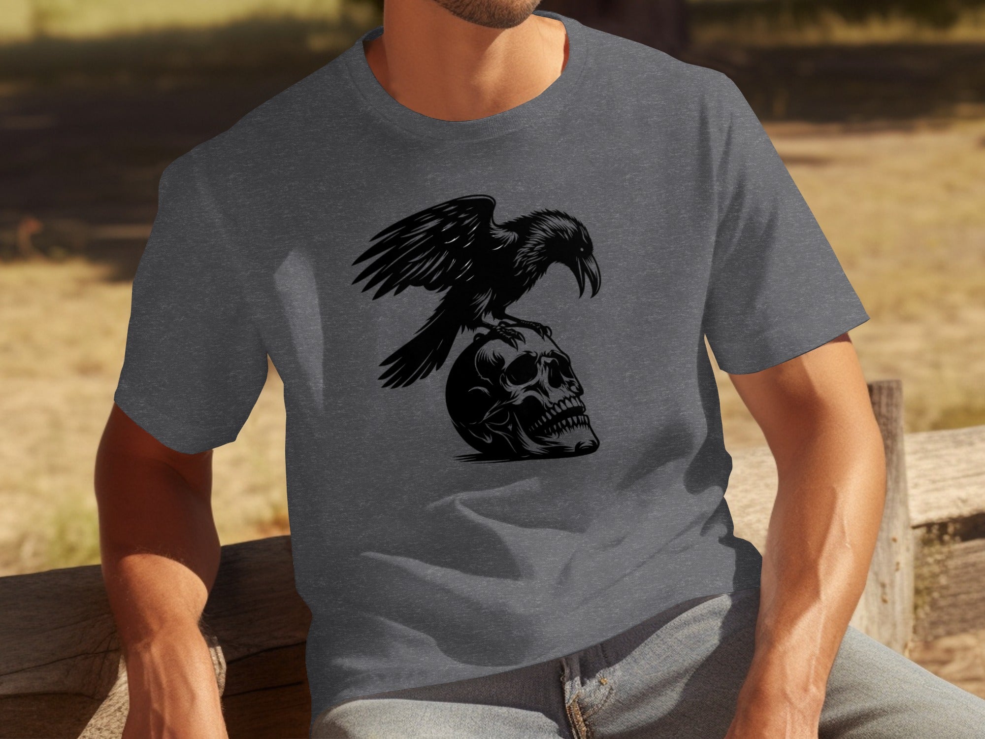 T-shirt with black print of a raven perched on a skull.