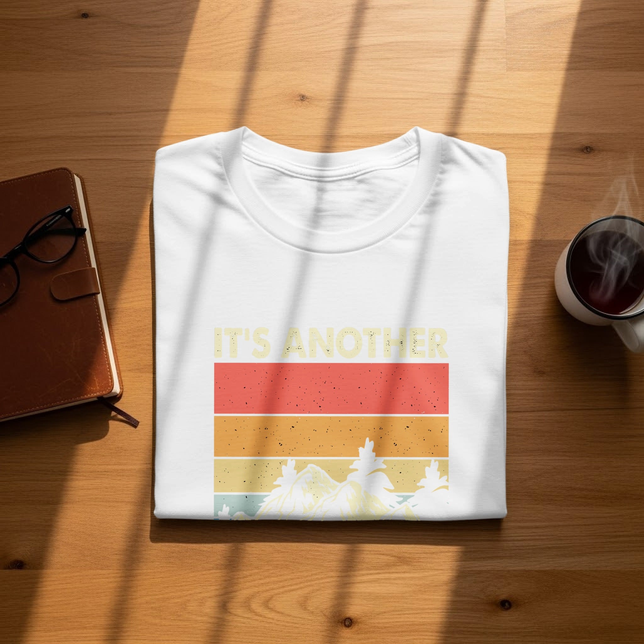 White t-shirt with retro mountain scene and text "IT'S ANOTHER"