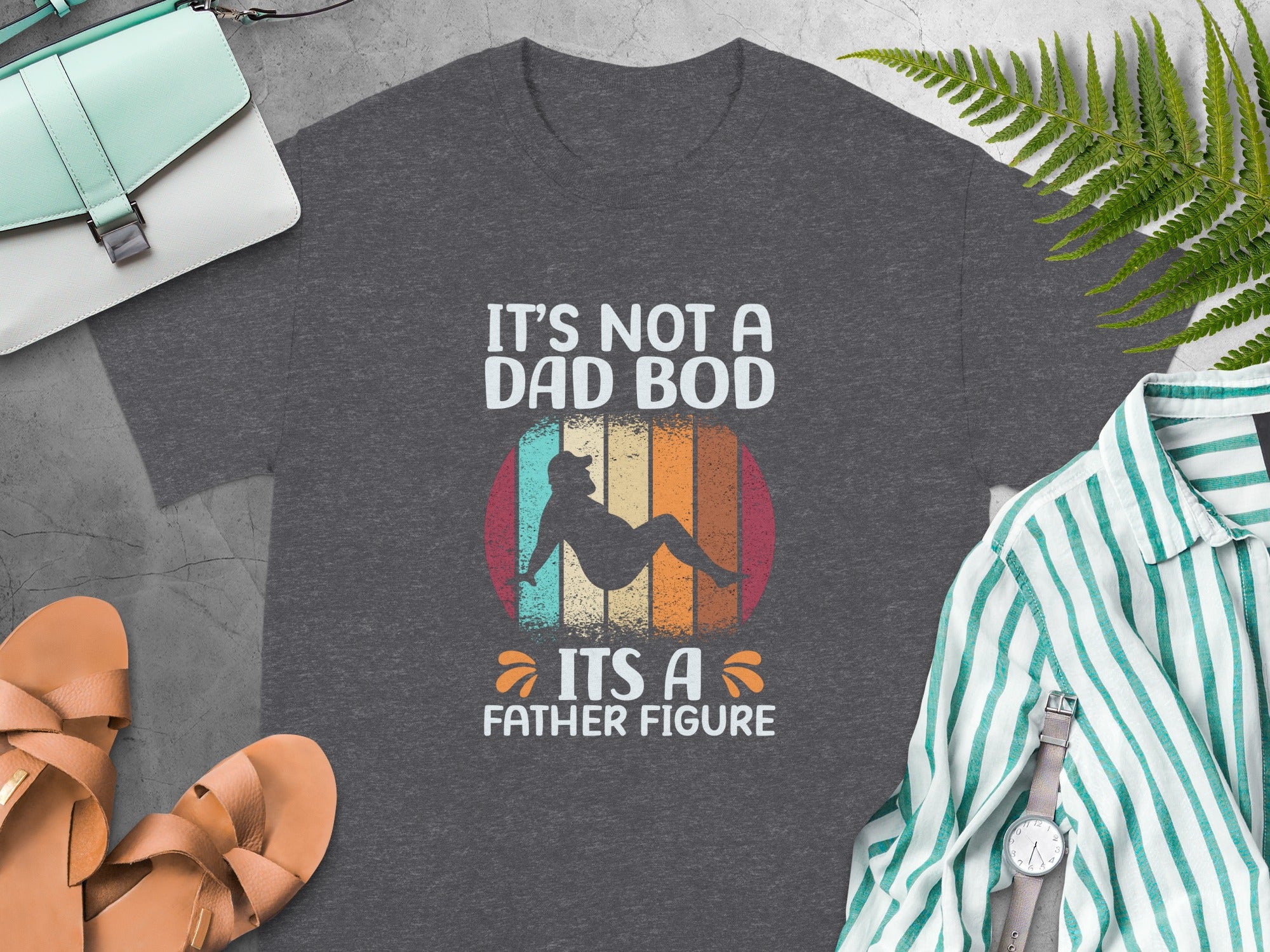 Dark gray t-shirt with "It's Not A Dad Bod It's A Father Figure" text and graphic.