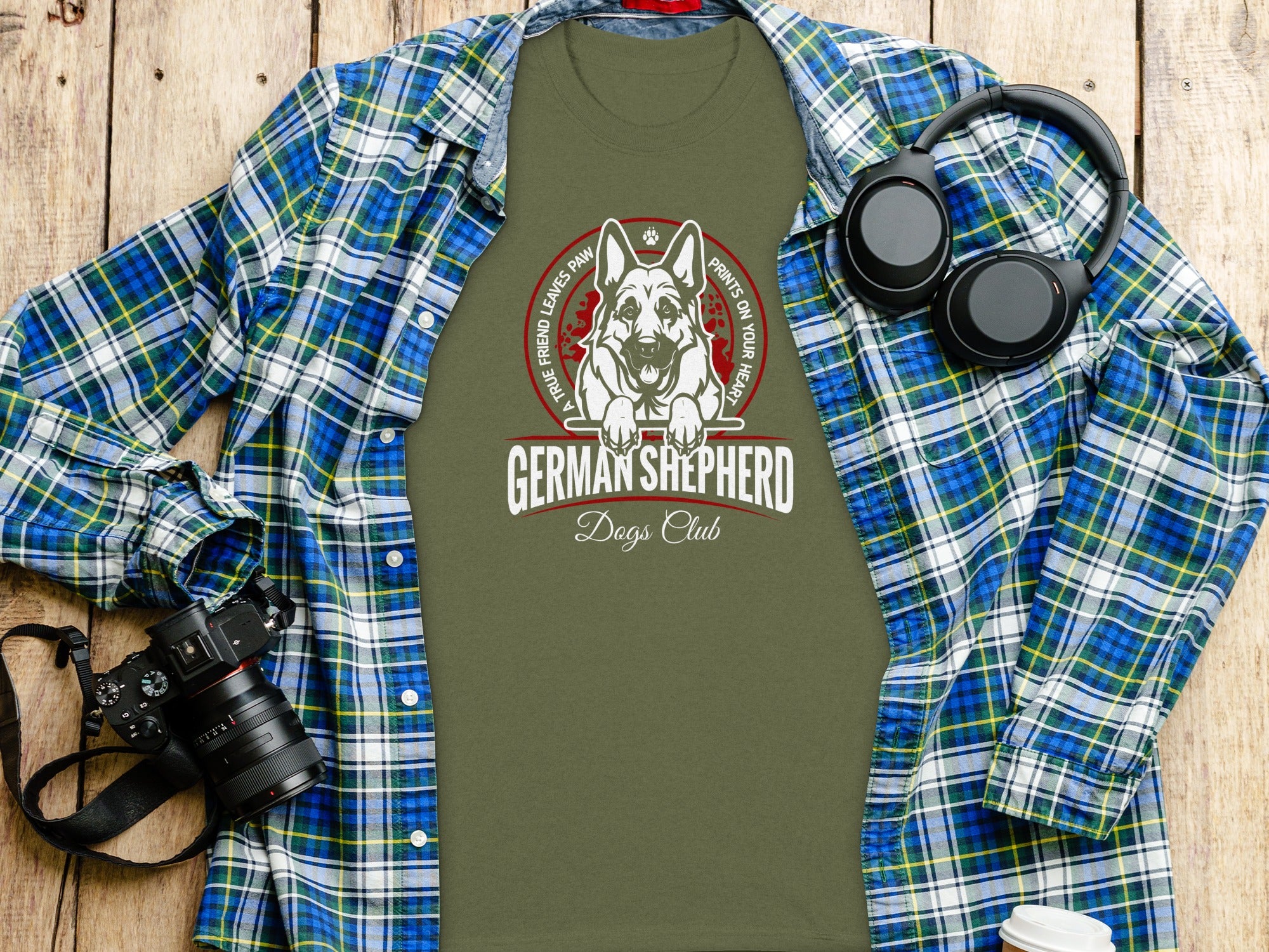 German Shepherd Dogs Club graphic on a green t-shirt with plaid shirt and headphones.