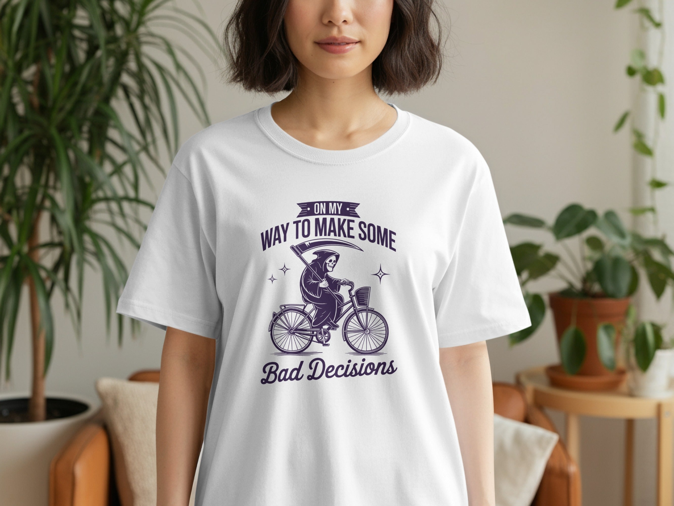 White t-shirt with purple text "ON MY WAY TO MAKE SOME Bad Decisions" and grim reaper on a bike.