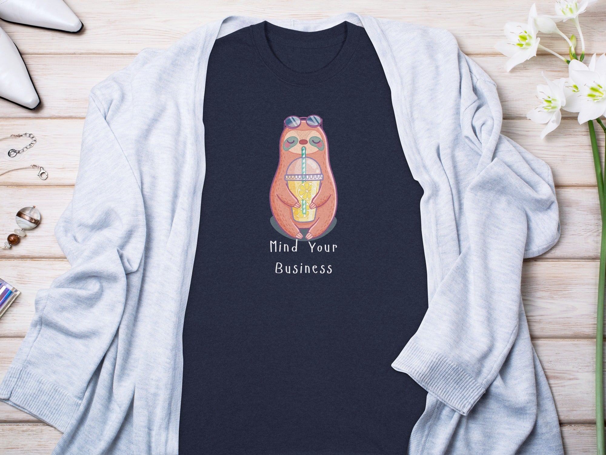 Dark navy t-shirt with sloth graphic and text "Mind Your Business".