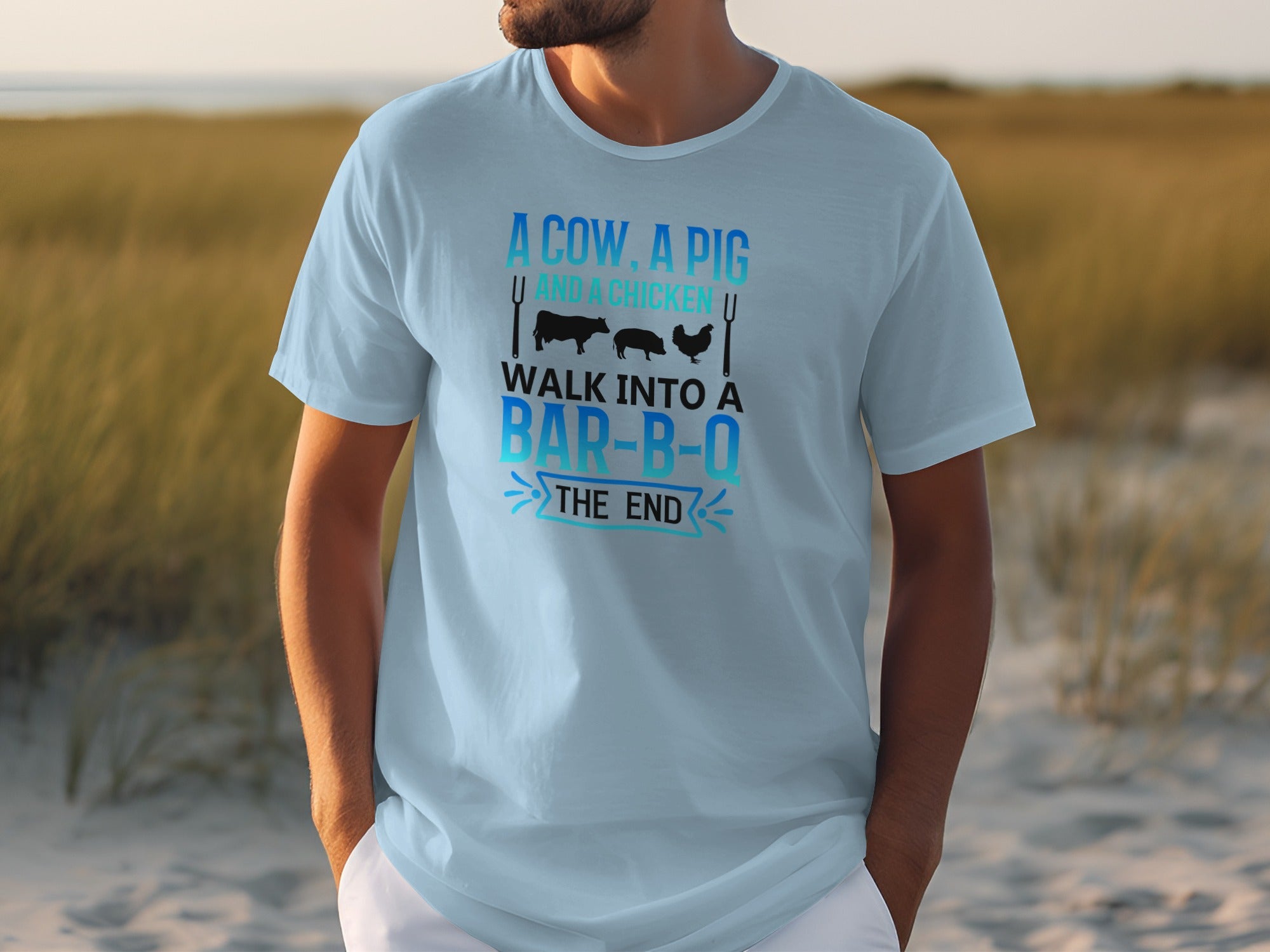 Light blue t-shirt with text "A cow, a pig and a chicken walk into a bar-b-o the end".