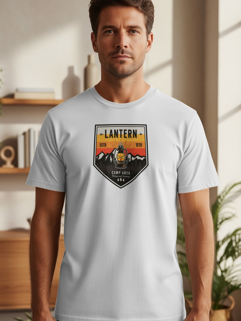 White t-shirt with a crest featuring a lantern, mountains, trees, and text "LANTERN ESTB 1978 CAMP AREA".