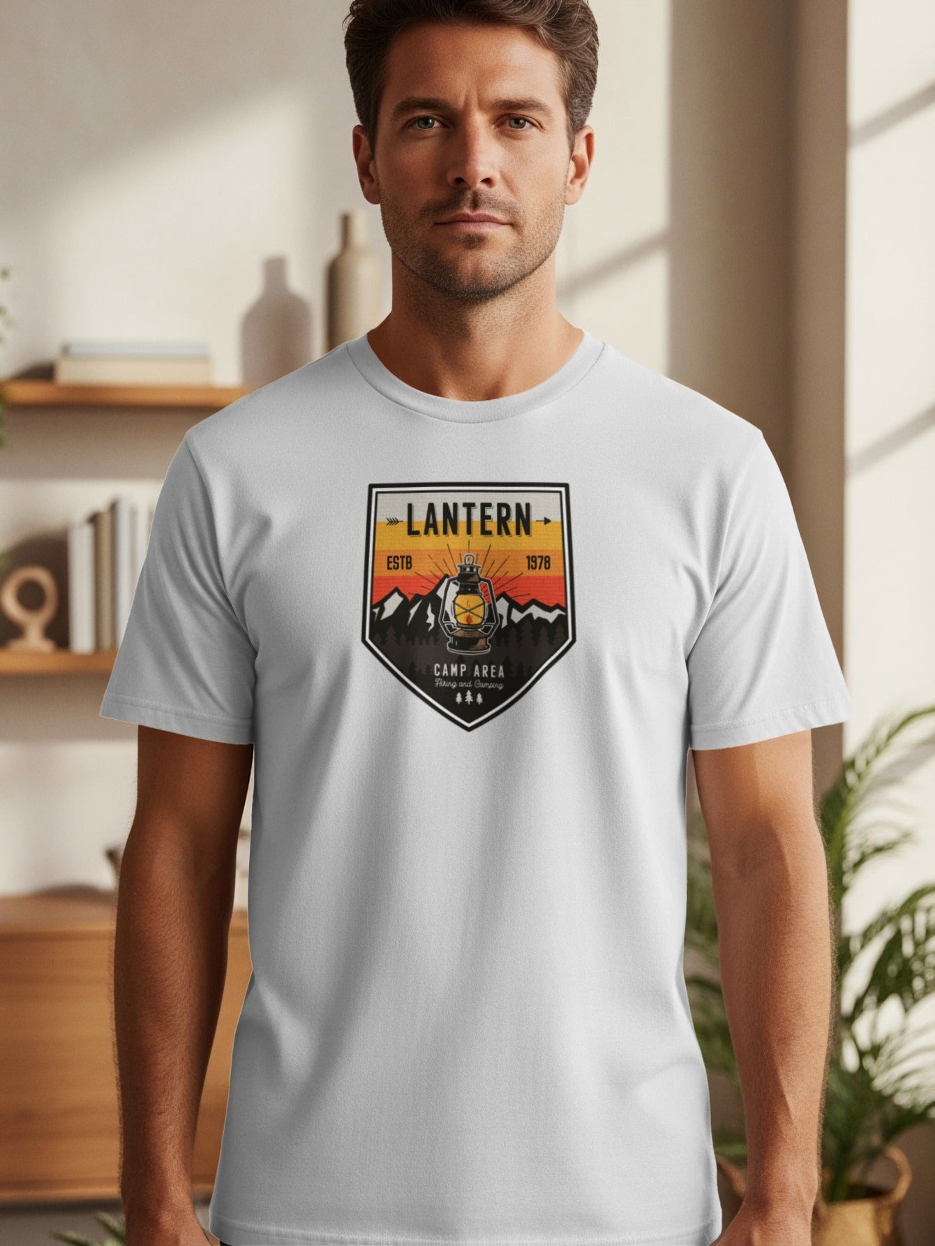 White t-shirt with a crest featuring a lantern, mountains, trees, and text "LANTERN ESTB 1978 CAMP AREA".