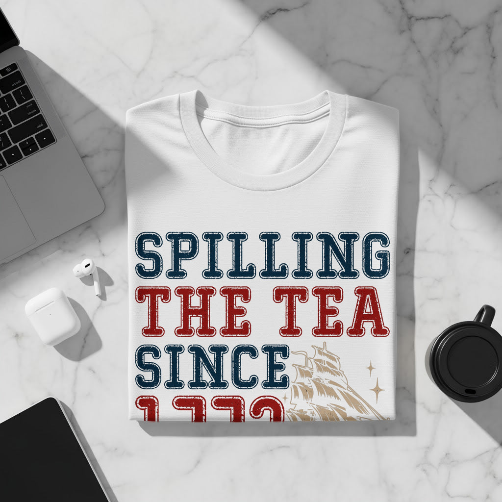 White t-shirt with red and blue text that says "SPILLING THE TEA SINCE 1773" and ship graphic.