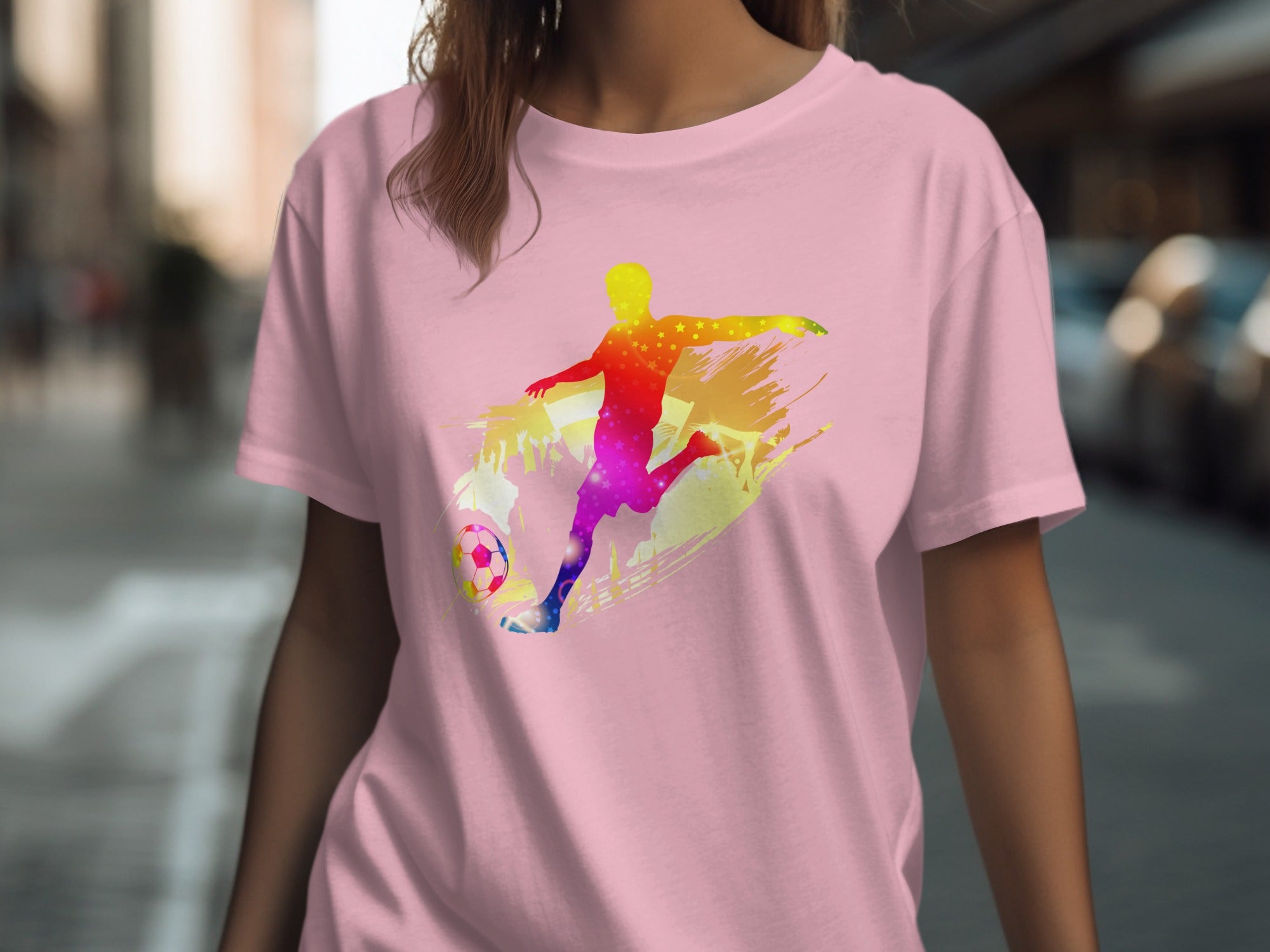 Pink t-shirt with colorful gradient soccer player silhouette and soccer ball graphic.