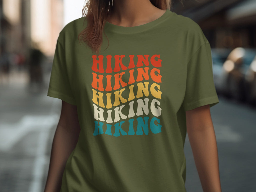 Olive green t-shirt with stacked "Hiking" text in retro font and colors.