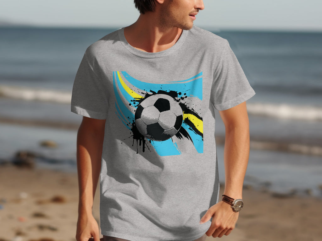 Gray t-shirt with black and white soccer ball and blue and yellow abstract design.