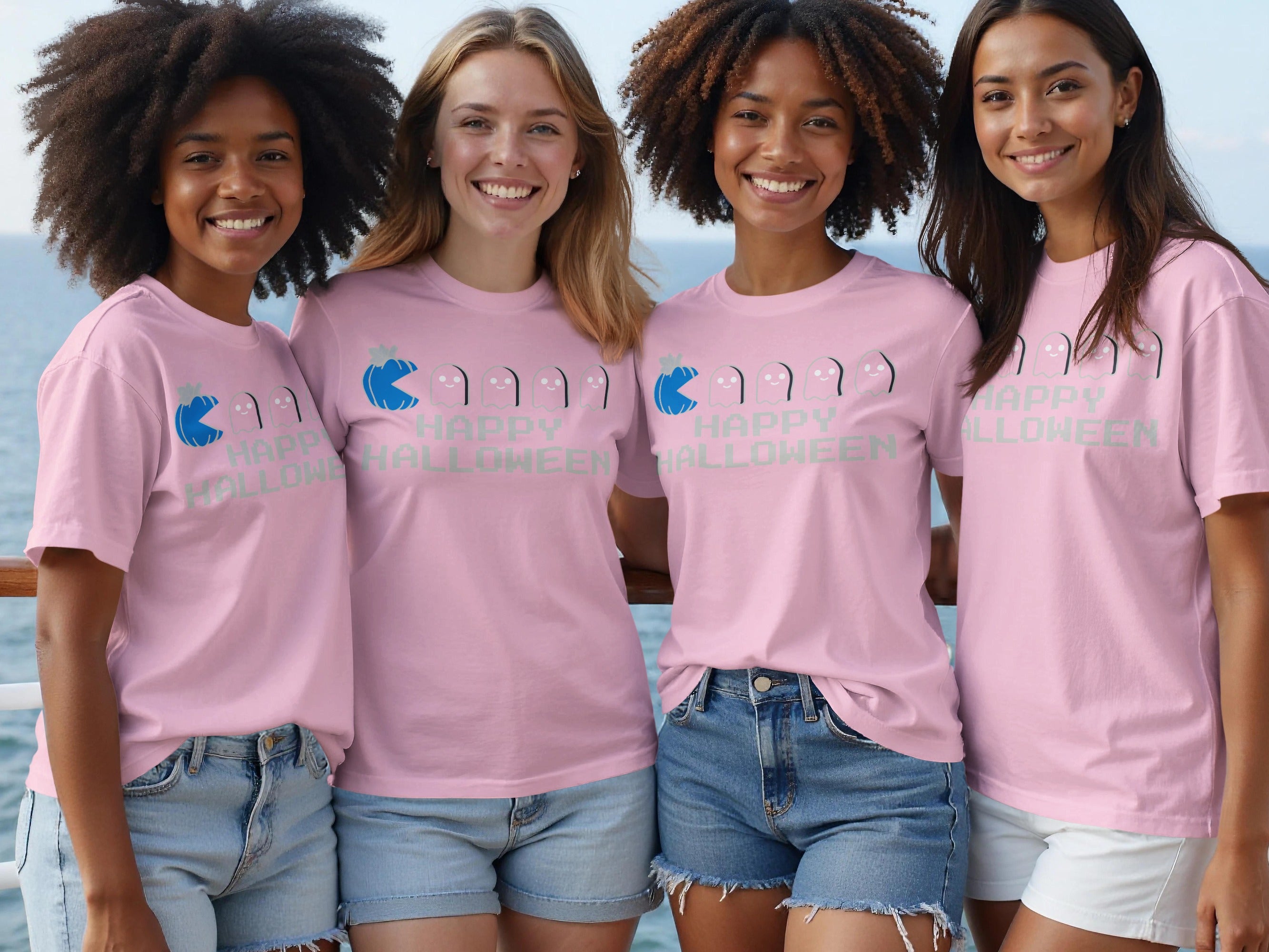 Four women wear pink t-shirts with "Happy Halloween" and ghost graphic.
