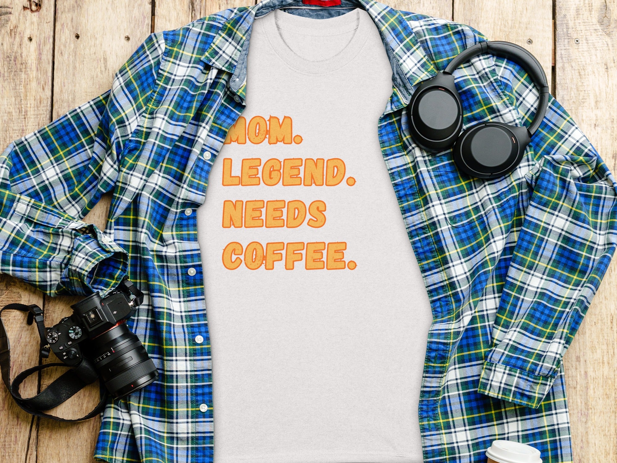 T-shirt with text MOM. LEGEND. NEEDS COFFEE. and a plaid shirt.
