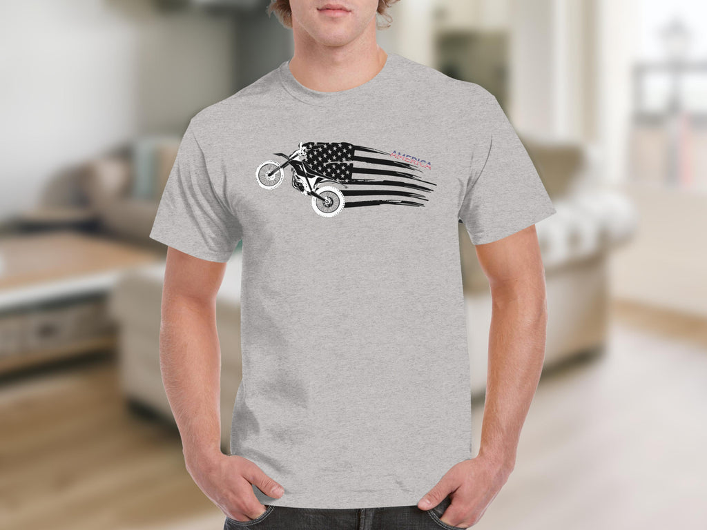 Dirt bike graphic with distressed American flag and "AMERICA" text on a gray t-shirt.