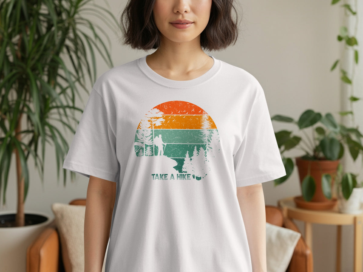 White t-shirt with vintage sunset graphic and "TAKE A HIKE" text.