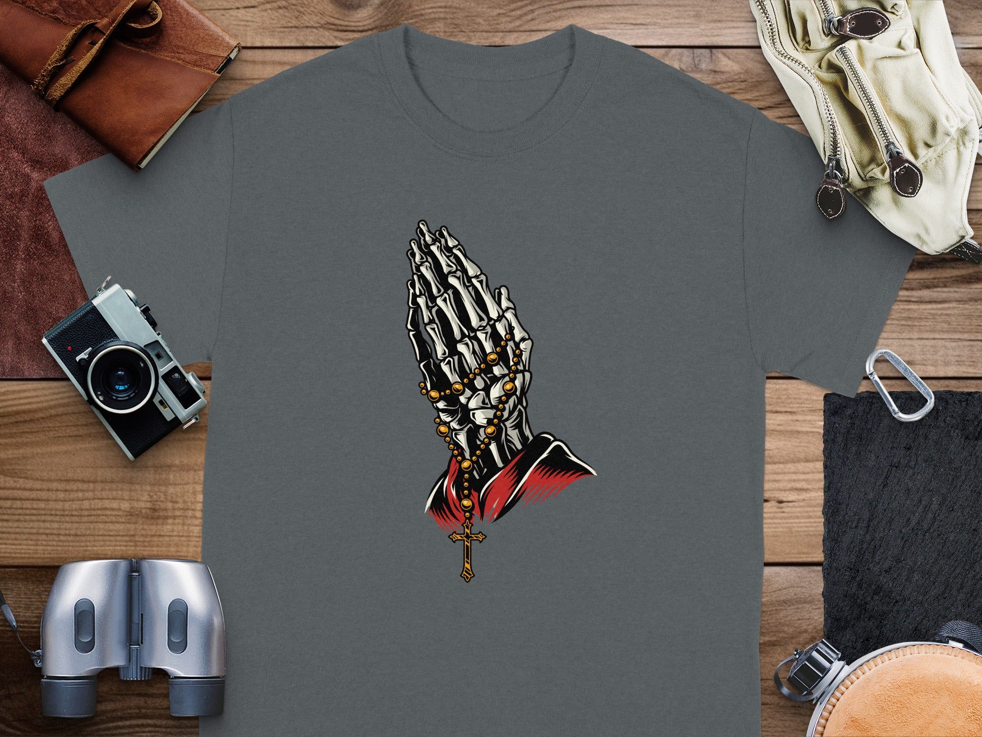 Dark gray t-shirt with skeleton hands praying wearing a rosary and cross.