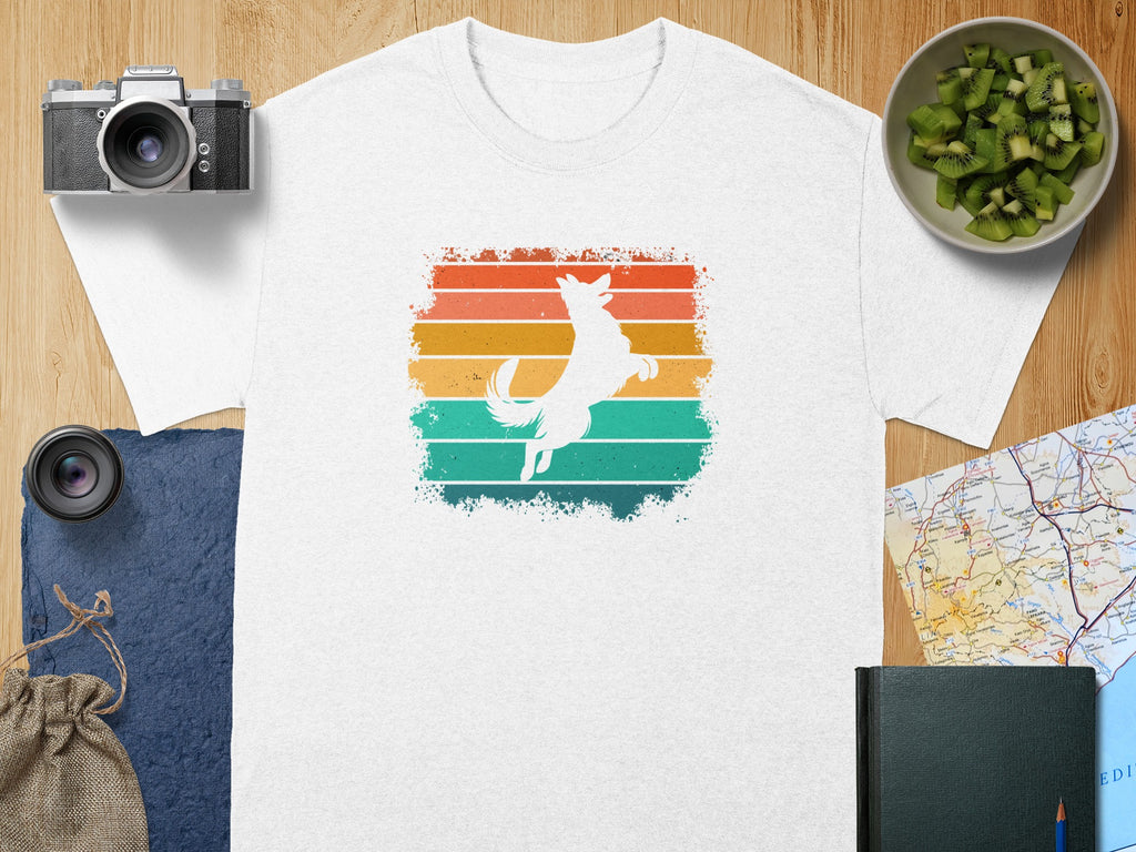 White t-shirt with white jumping dog silhouette over retro stripes.
