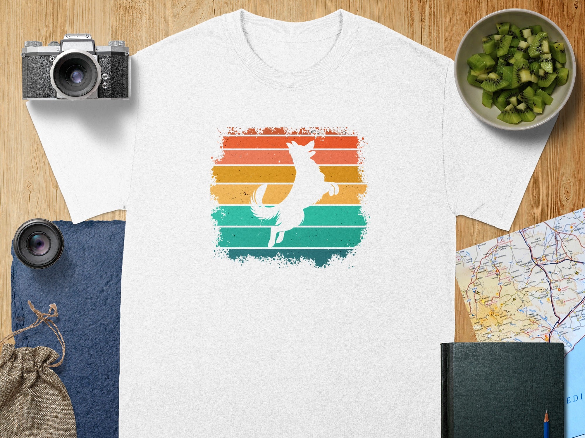 White t-shirt with white jumping dog silhouette over retro stripes.