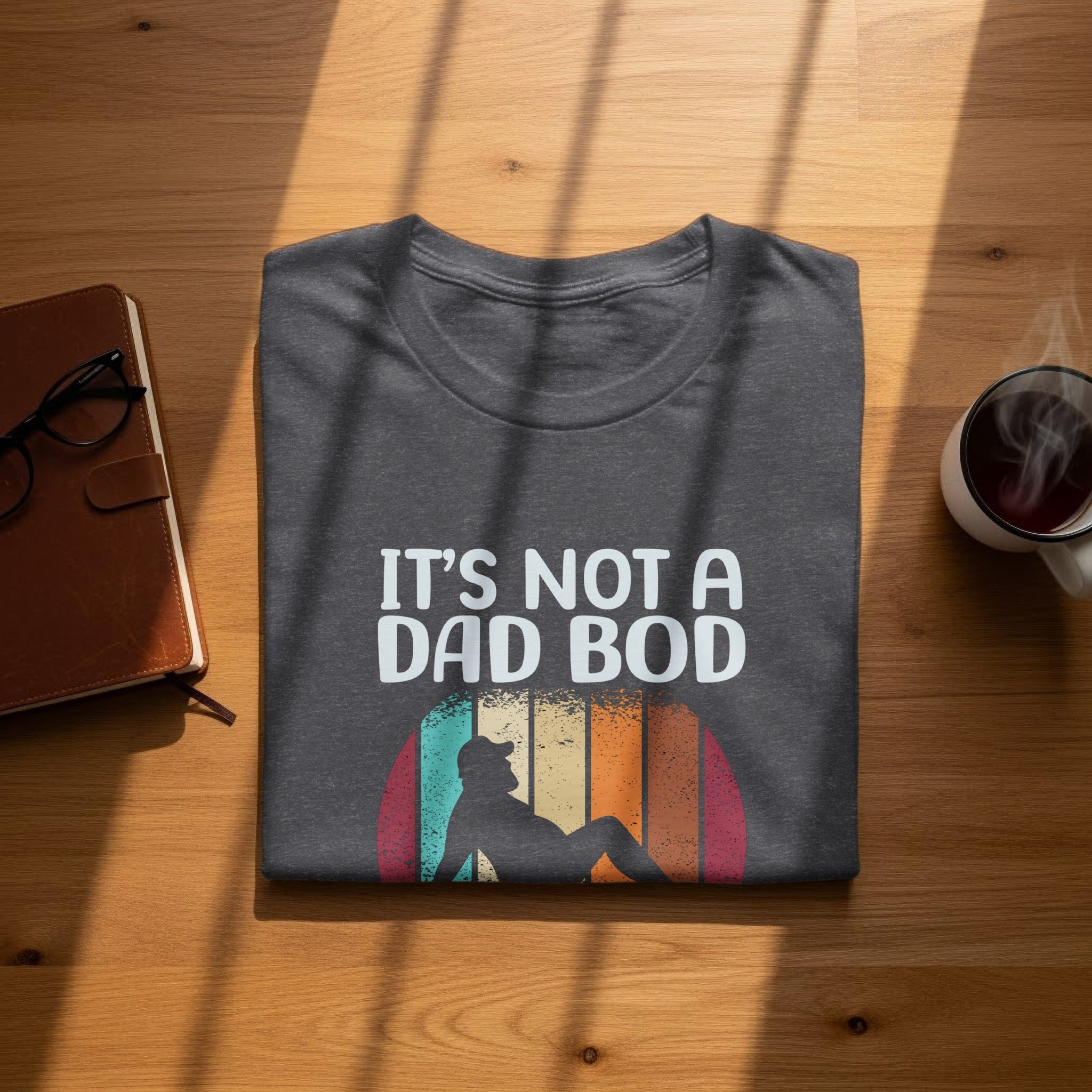 Dark grey t-shirt with "IT'S NOT A DAD BOD" and retro graphic.