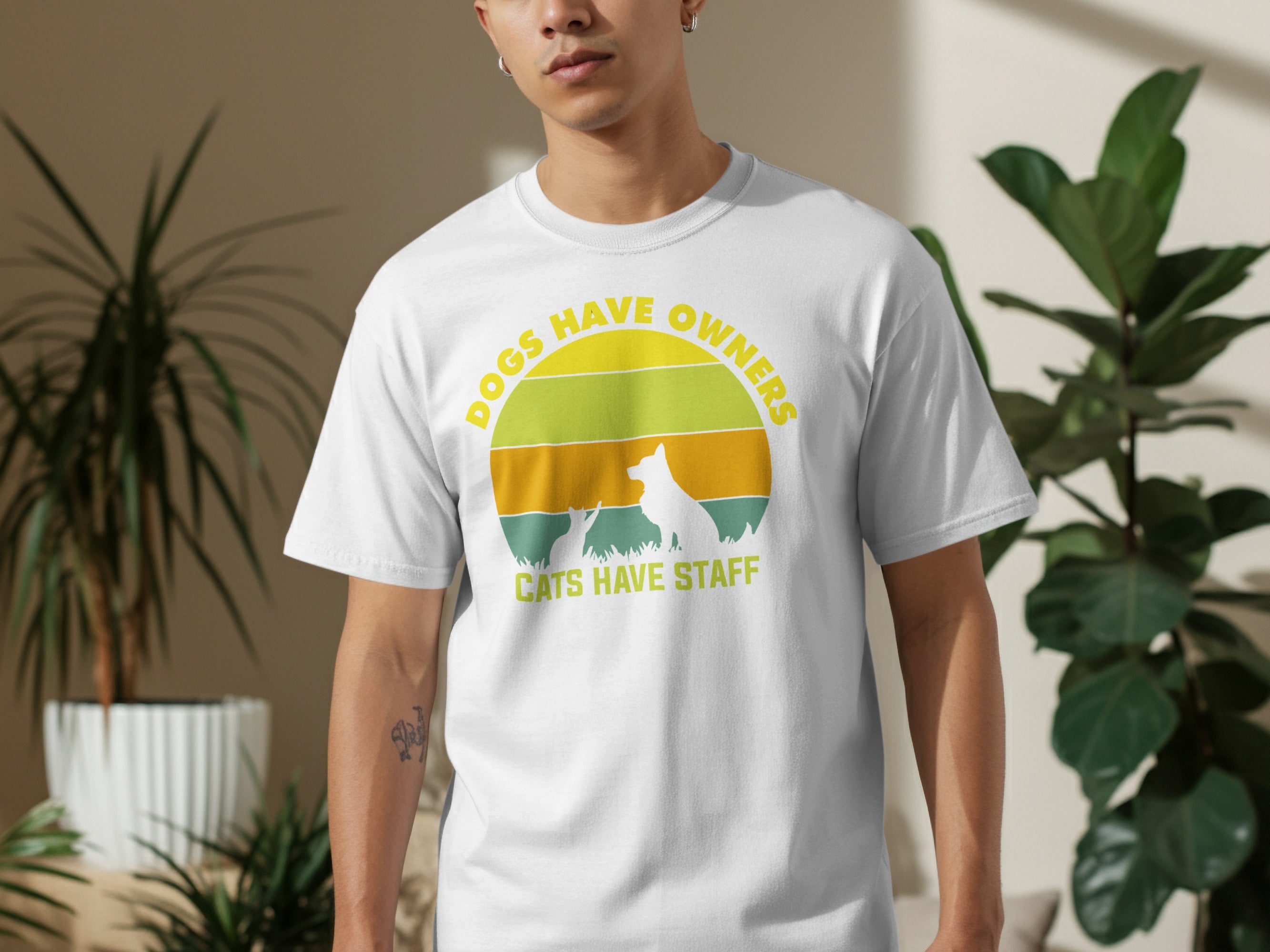 White t-shirt with graphic: "DOGS HAVE OWNERS CATS HAVE STAFF."