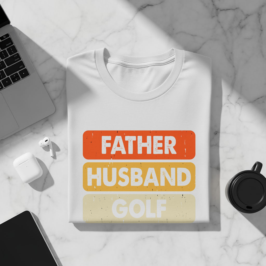 White t-shirt with "Father Husband Golf" text in distressed orange, yellow, and beige rectangles.