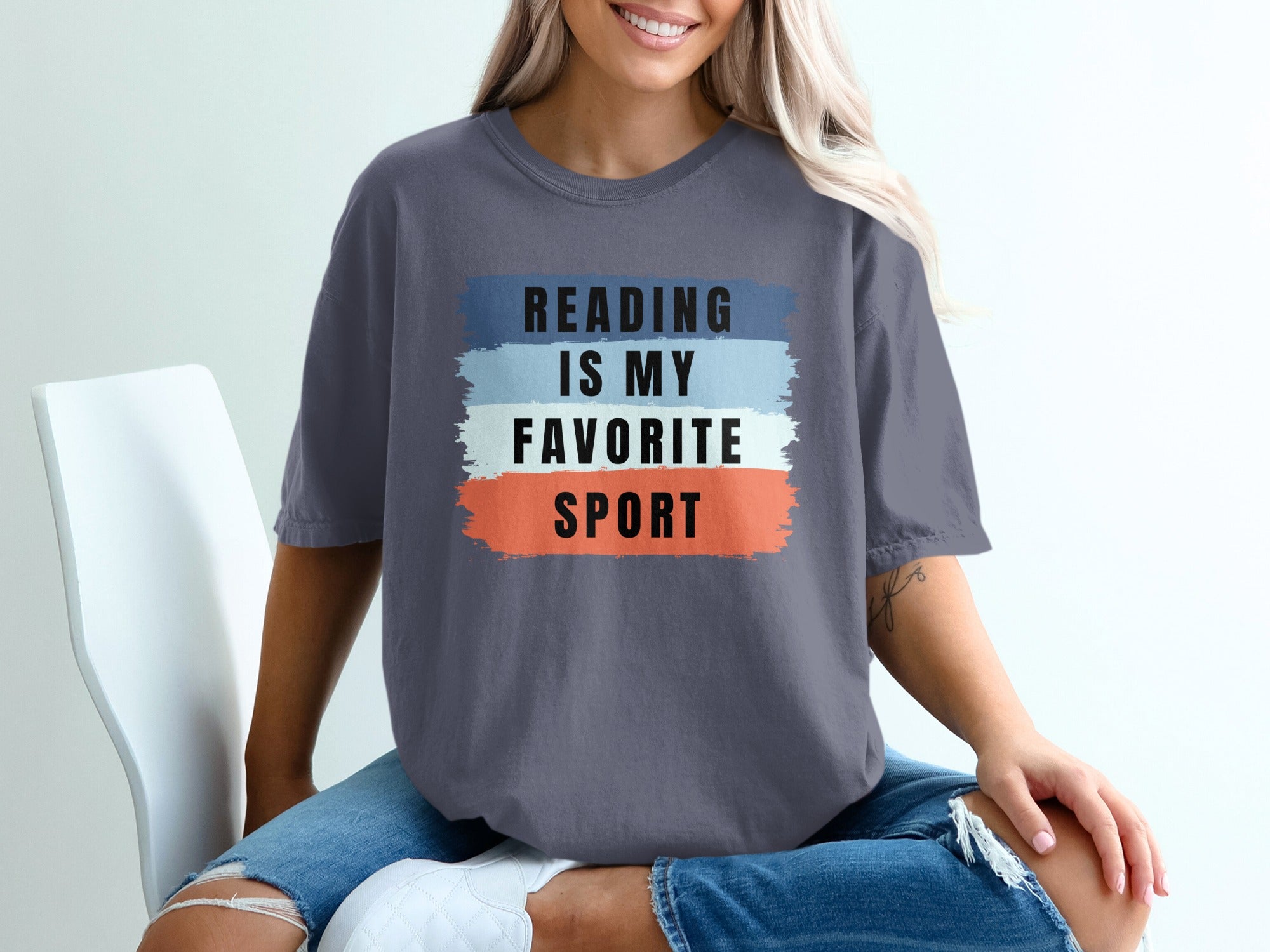 Grey t-shirt with text "Reading is my favorite sport" in black.