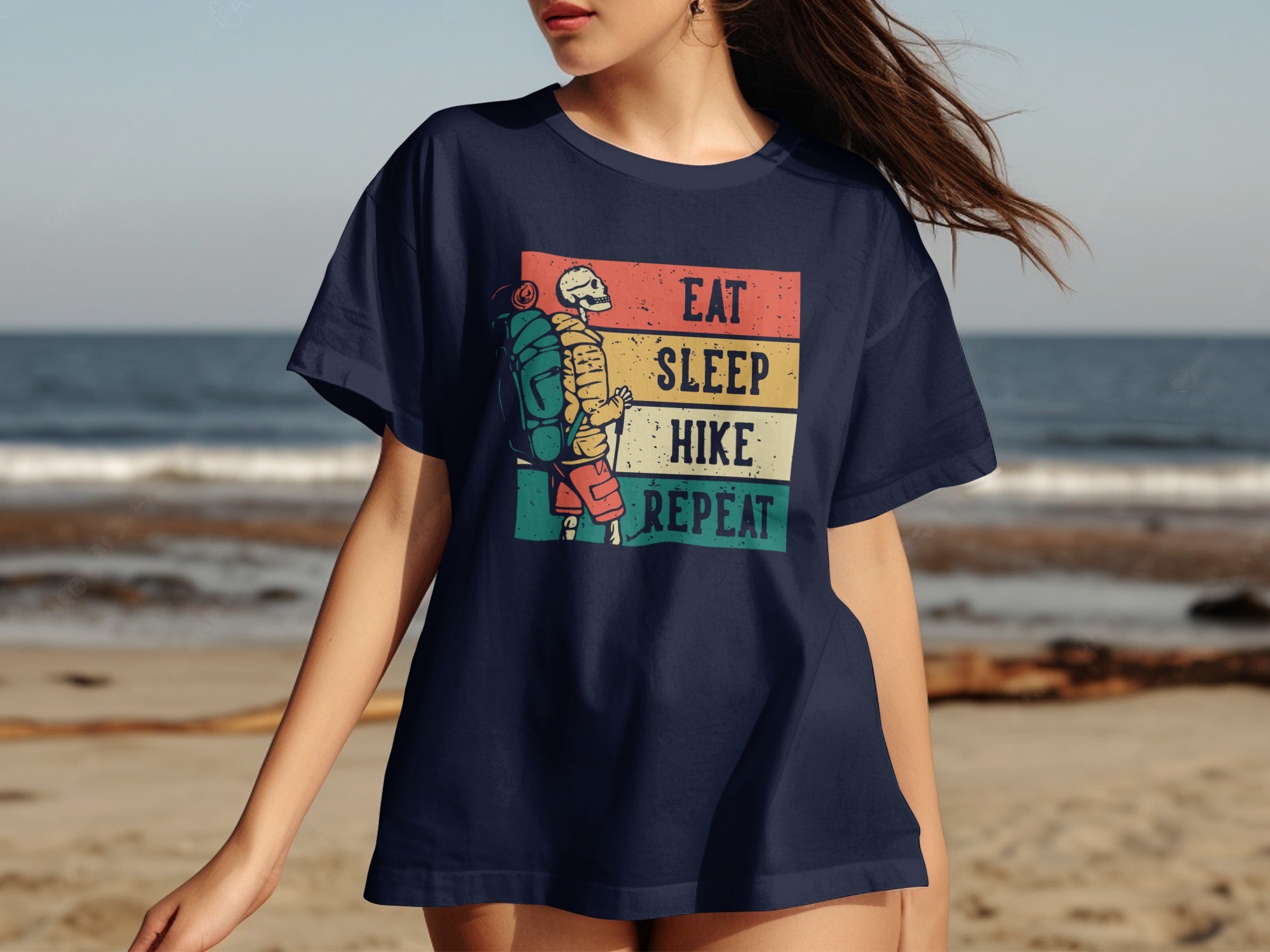 Navy t-shirt with "Eat Sleep Hike Repeat" text and skeleton hiker graphic.