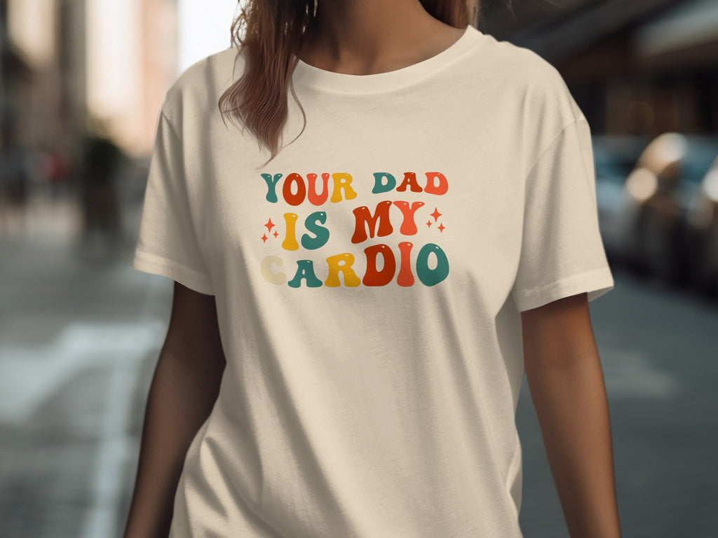 Cream t-shirt with retro text reading "YOUR DAD IS MY CARDIO"