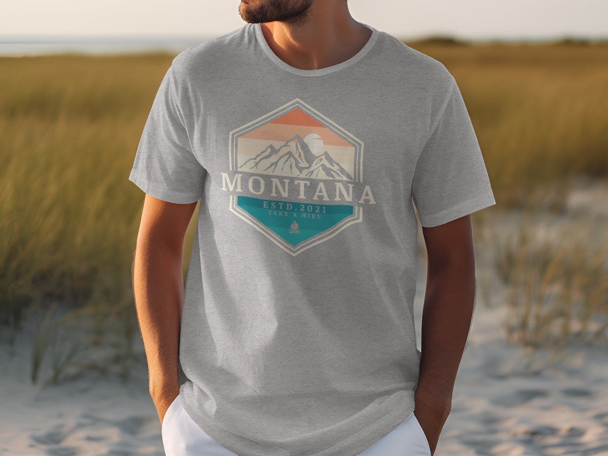 Grey t-shirt with "Montana Estd. 2021 Take a Hike" mountain graphic.