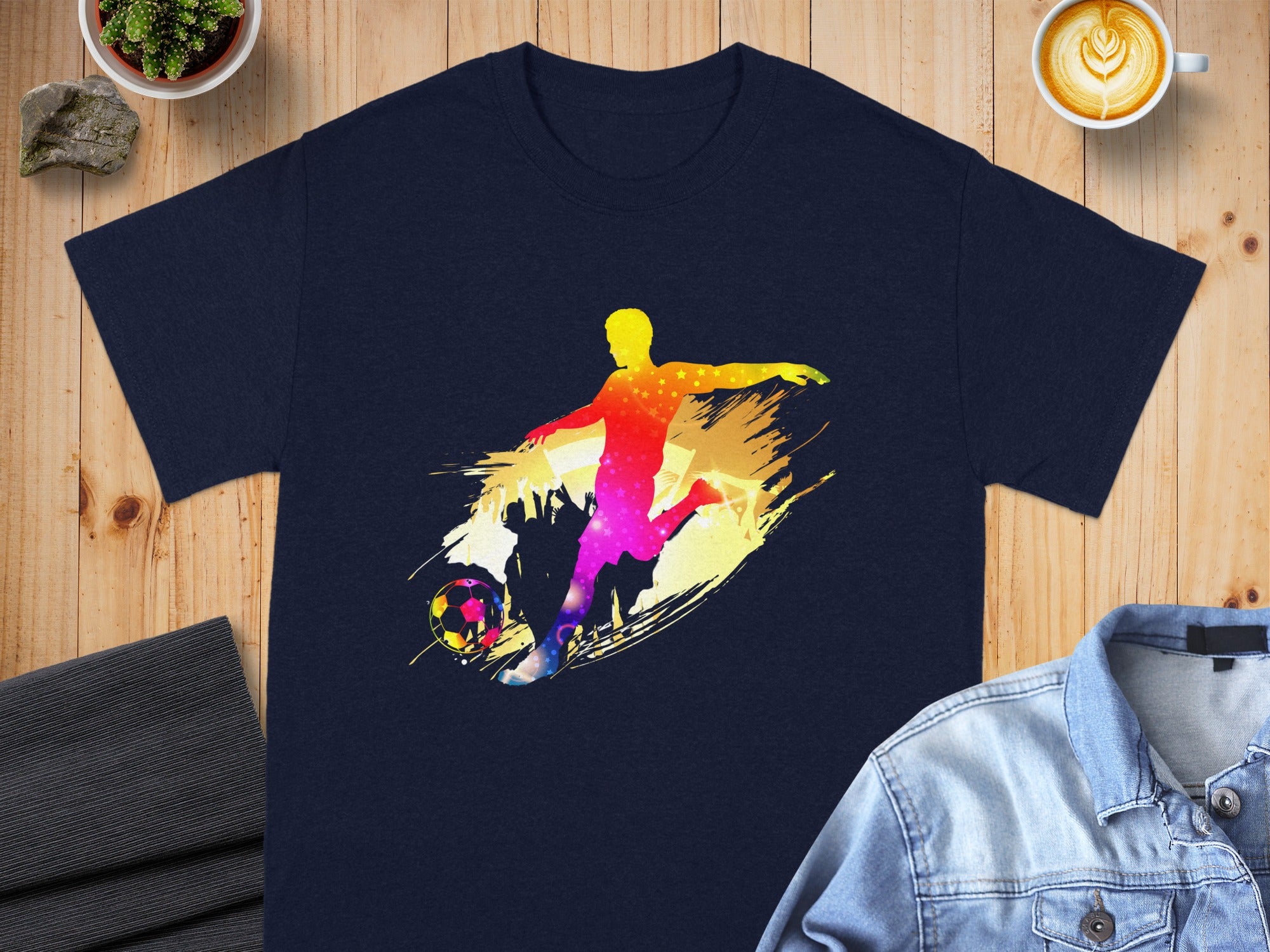 Dark navy t-shirt with colorful abstract soccer player and ball graphic.