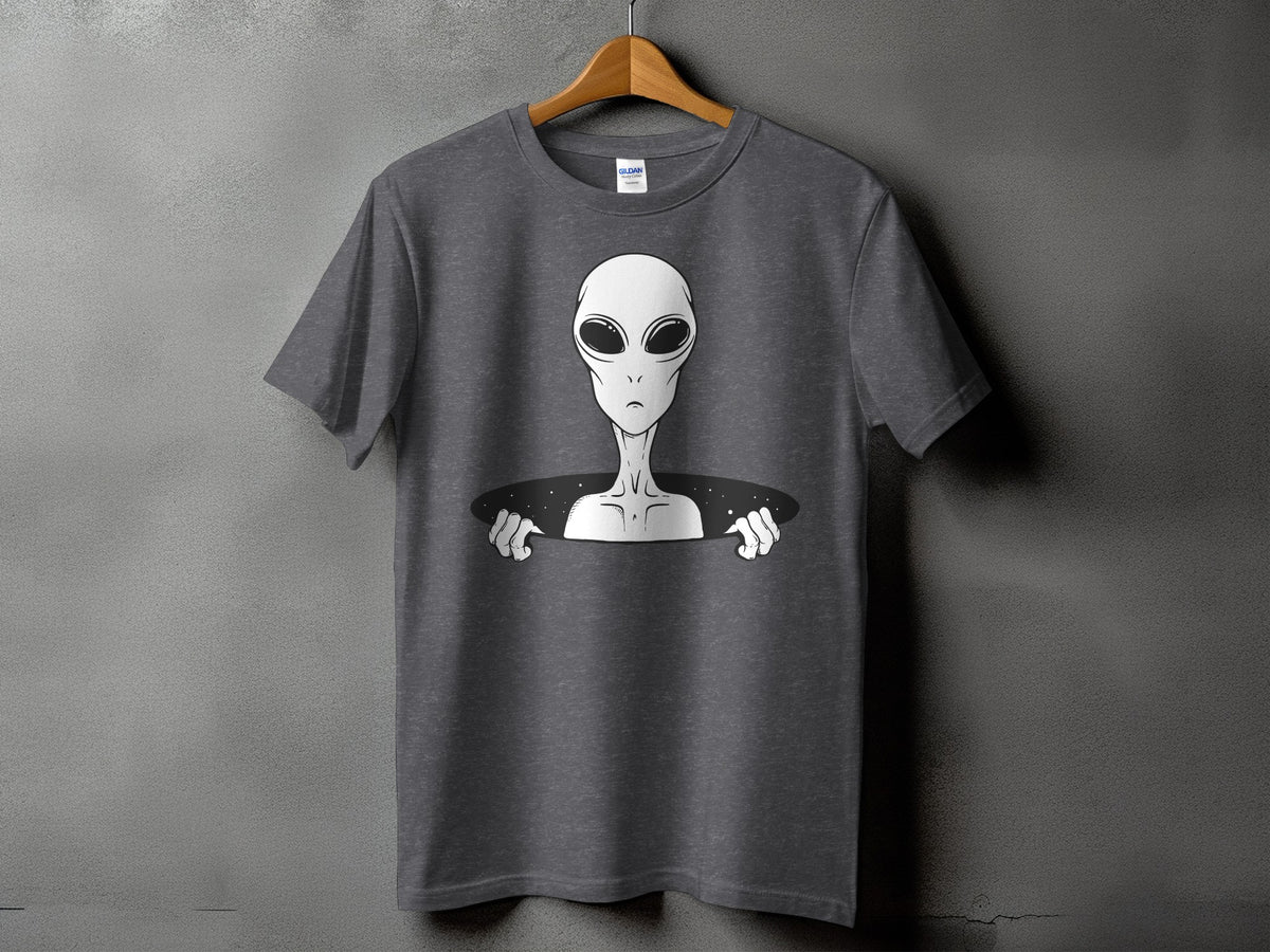 Gray t-shirt with a white alien emerging from a black oval space.