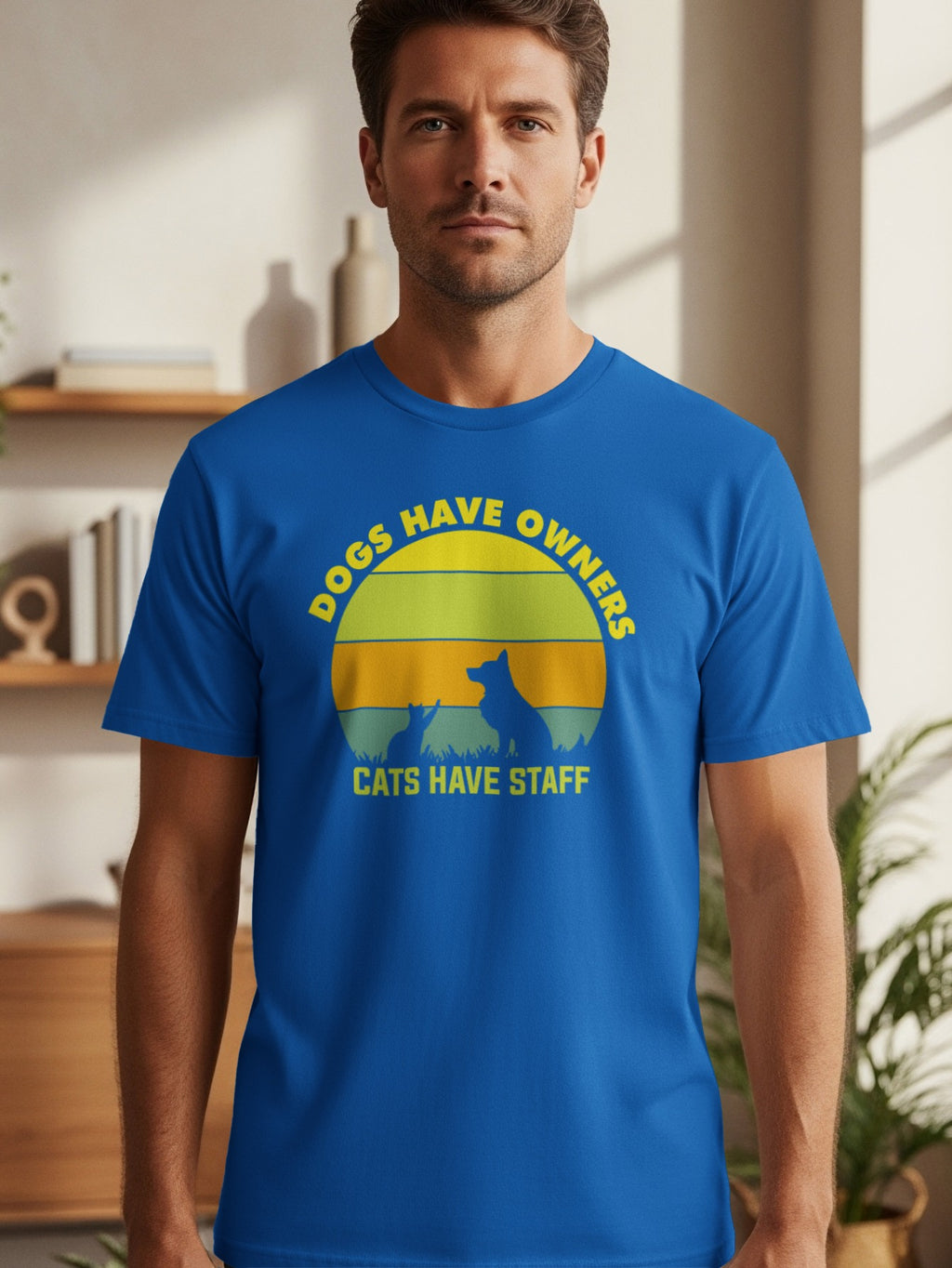 Blue t-shirt with "Dogs Have Owners, Cats Have Staff" text and animal silhouettes.