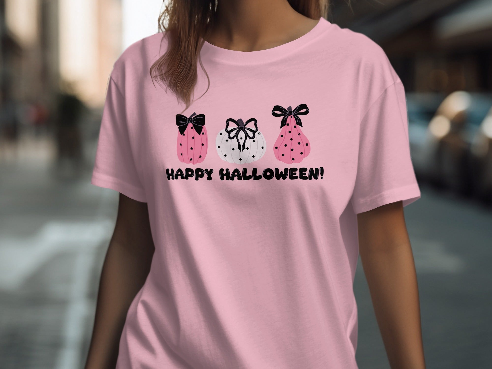 Pink t-shirt with three cartoon pumpkins and "Happy Halloween!" text.