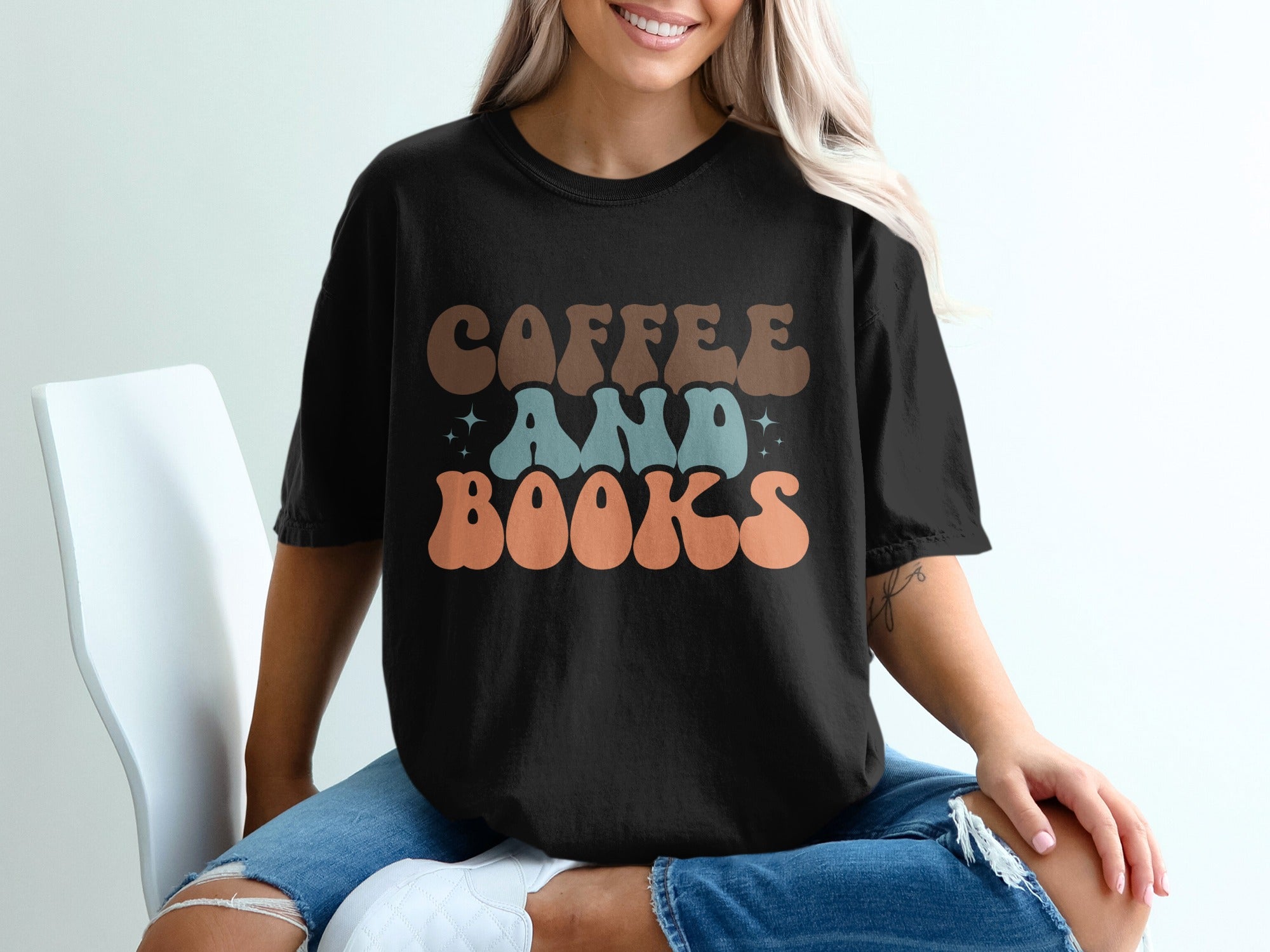Black t-shirt with a retro graphic reading "COFFEE AND BOOKS"