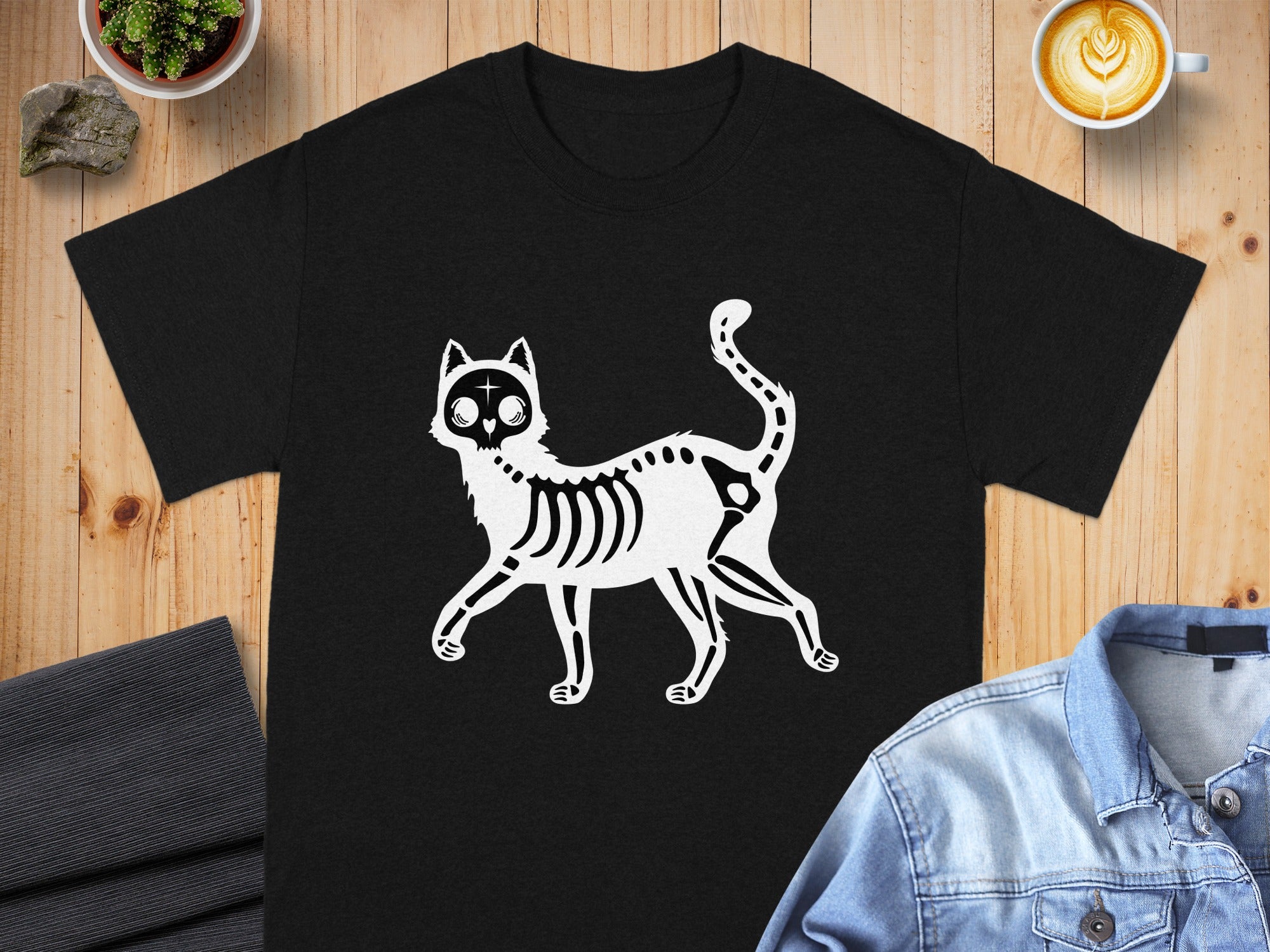 Black t-shirt with a white skeleton cat graphic and a plus sign on its forehead.