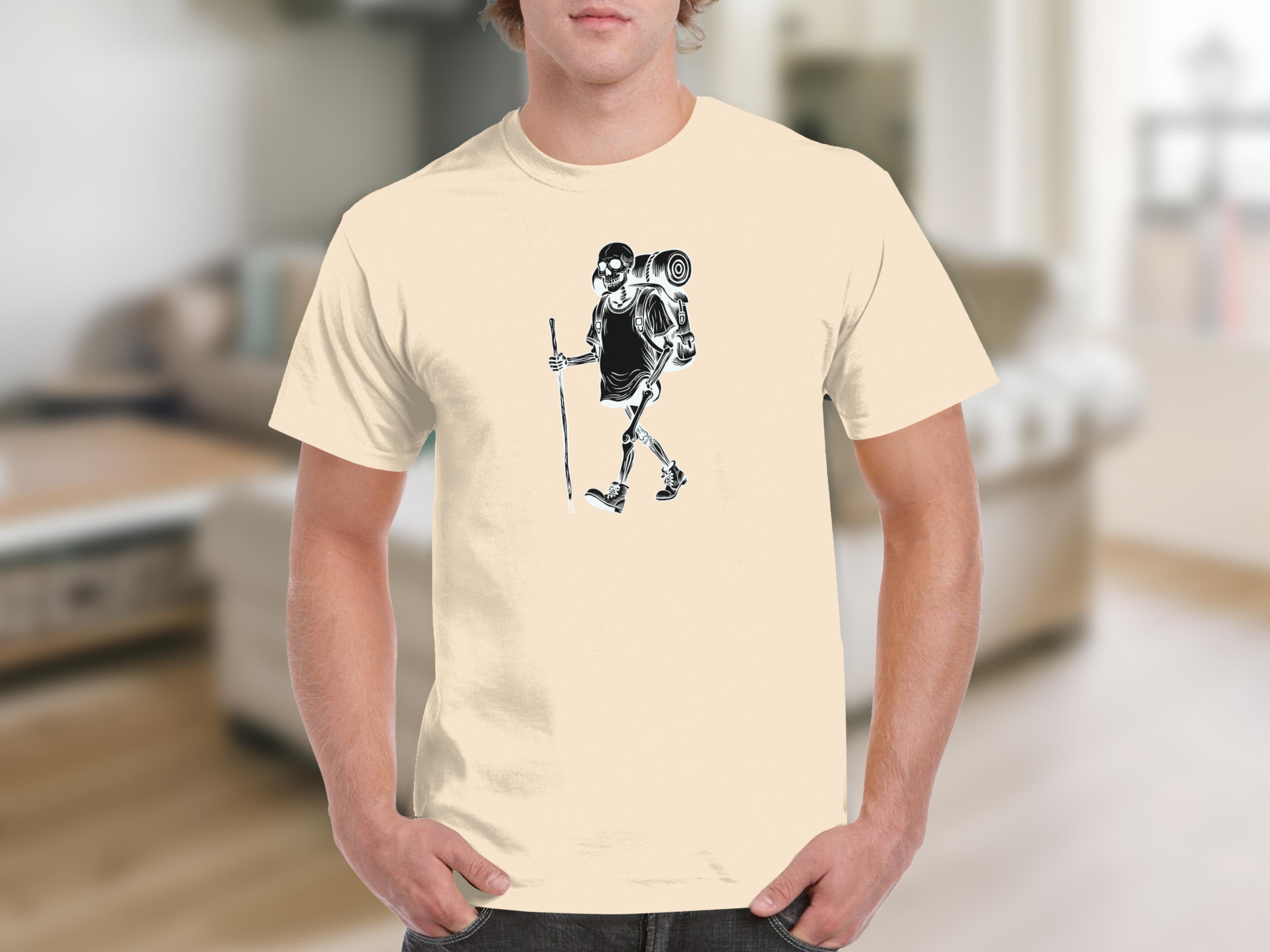 Skeleton hiker graphic on a light yellow t-shirt.