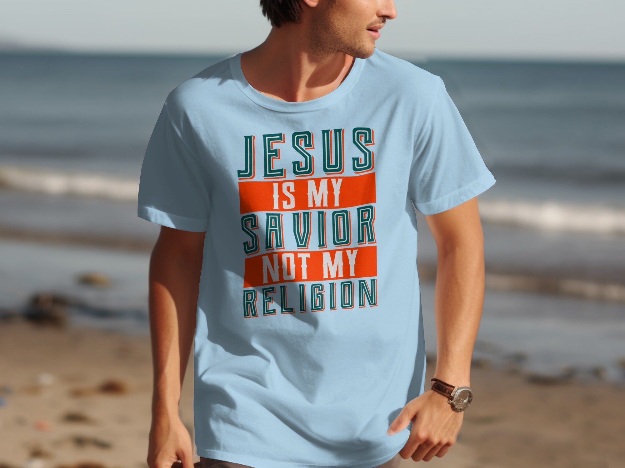 Light blue t-shirt with text: Jesus is my savior, not my religion.