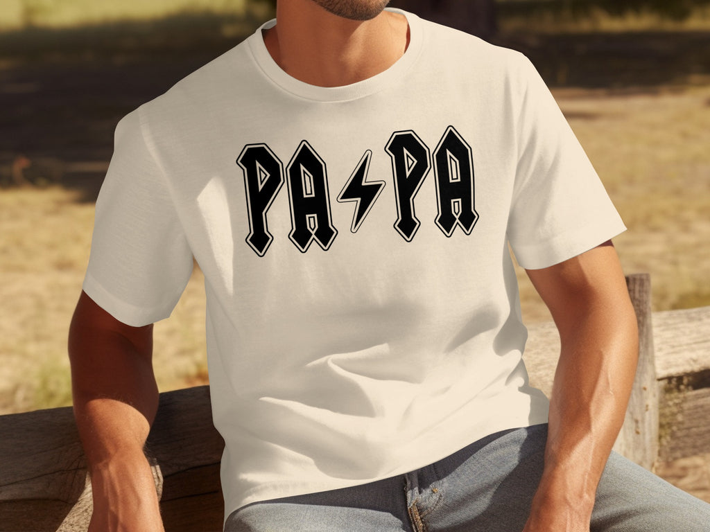 Cream t-shirt with black lettering spelling "PAPA" with a lightning bolt between the two sets of letters.
