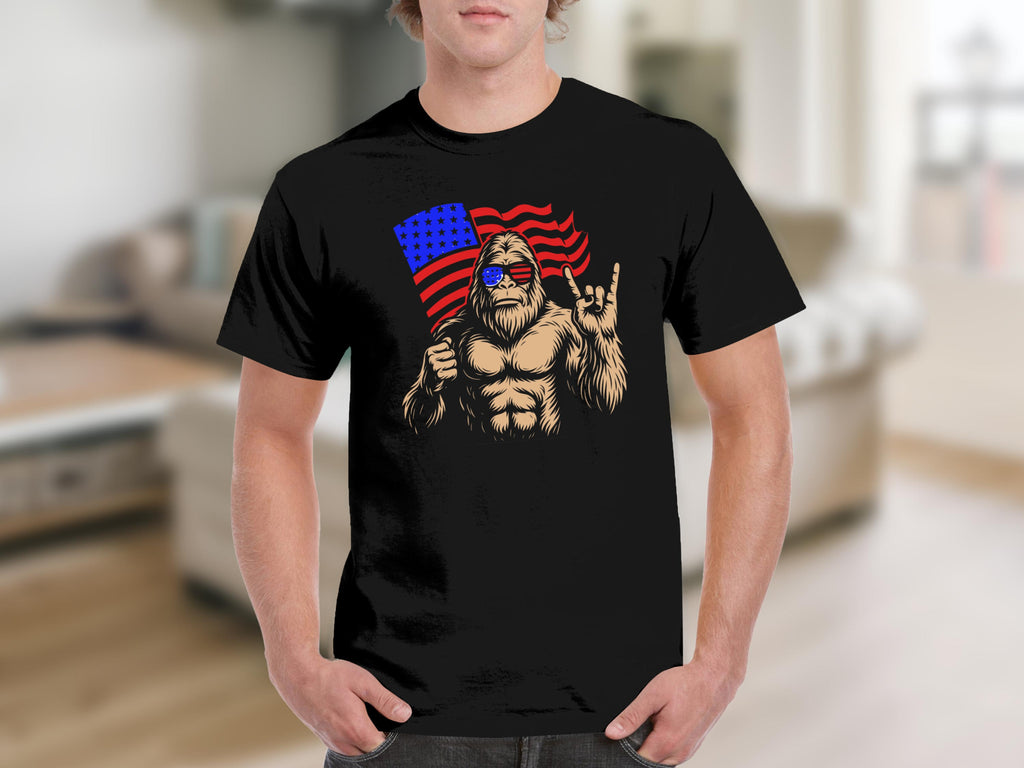 Bigfoot wearing sunglasses holding an American flag and making a rock on hand gesture.