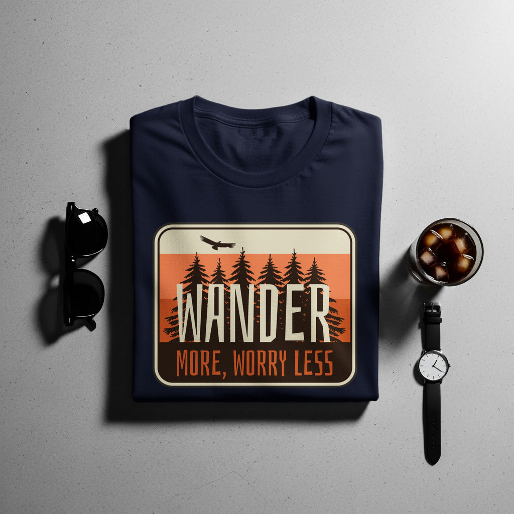 Navy t-shirt with "WANDER MORE, WORRY LESS" graphic and pine trees.