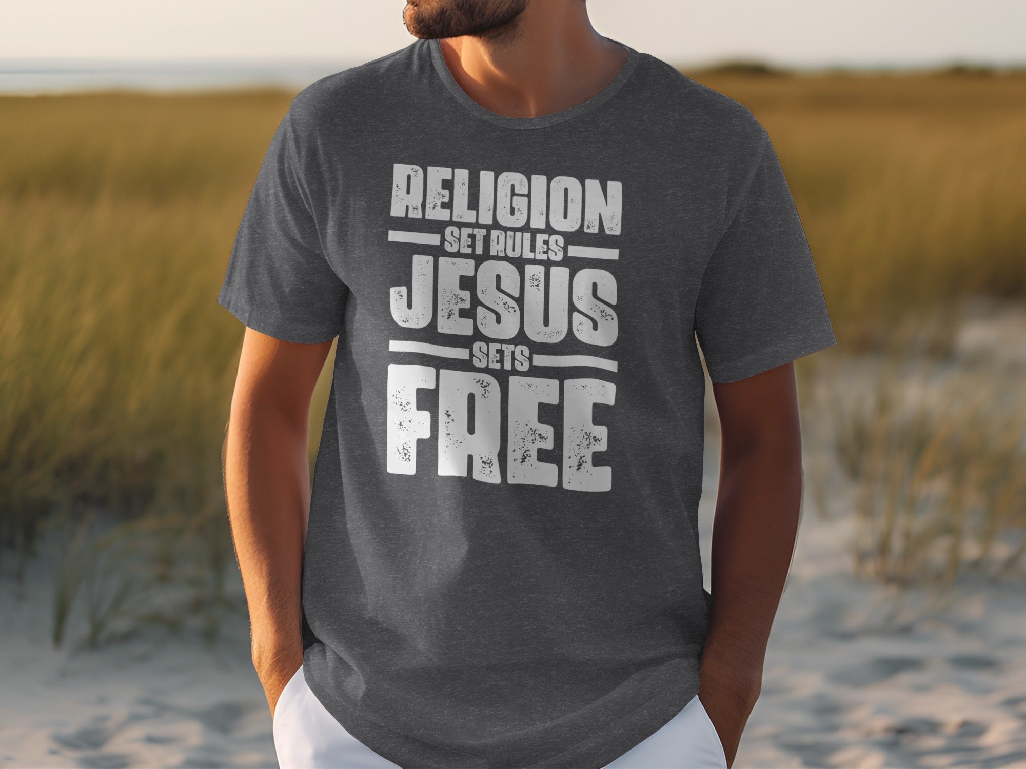Dark grey t-shirt with white text: "RELIGION SET RULES JESUS SETS FREE"