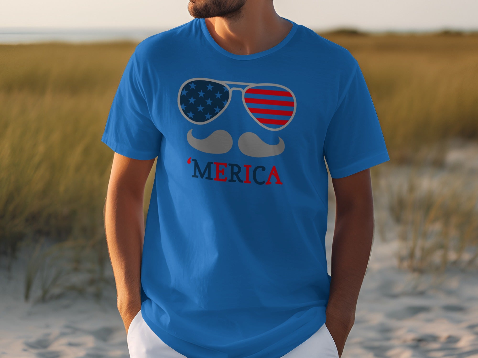 Blue t-shirt with sunglasses, mustache, and "MERICA" graphic in American flag style.