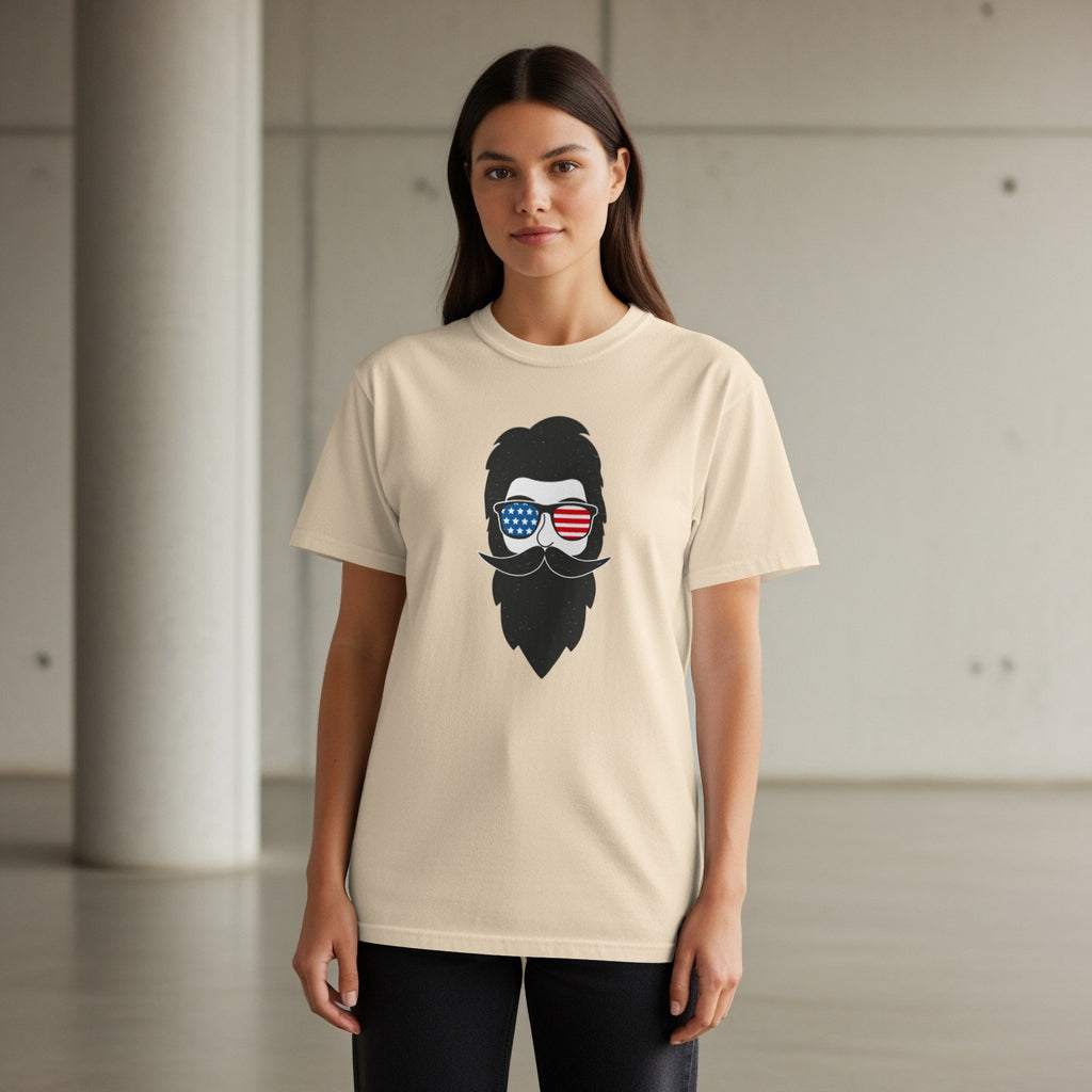 Beige t-shirt with a graphic of a bearded face wearing American flag sunglasses.