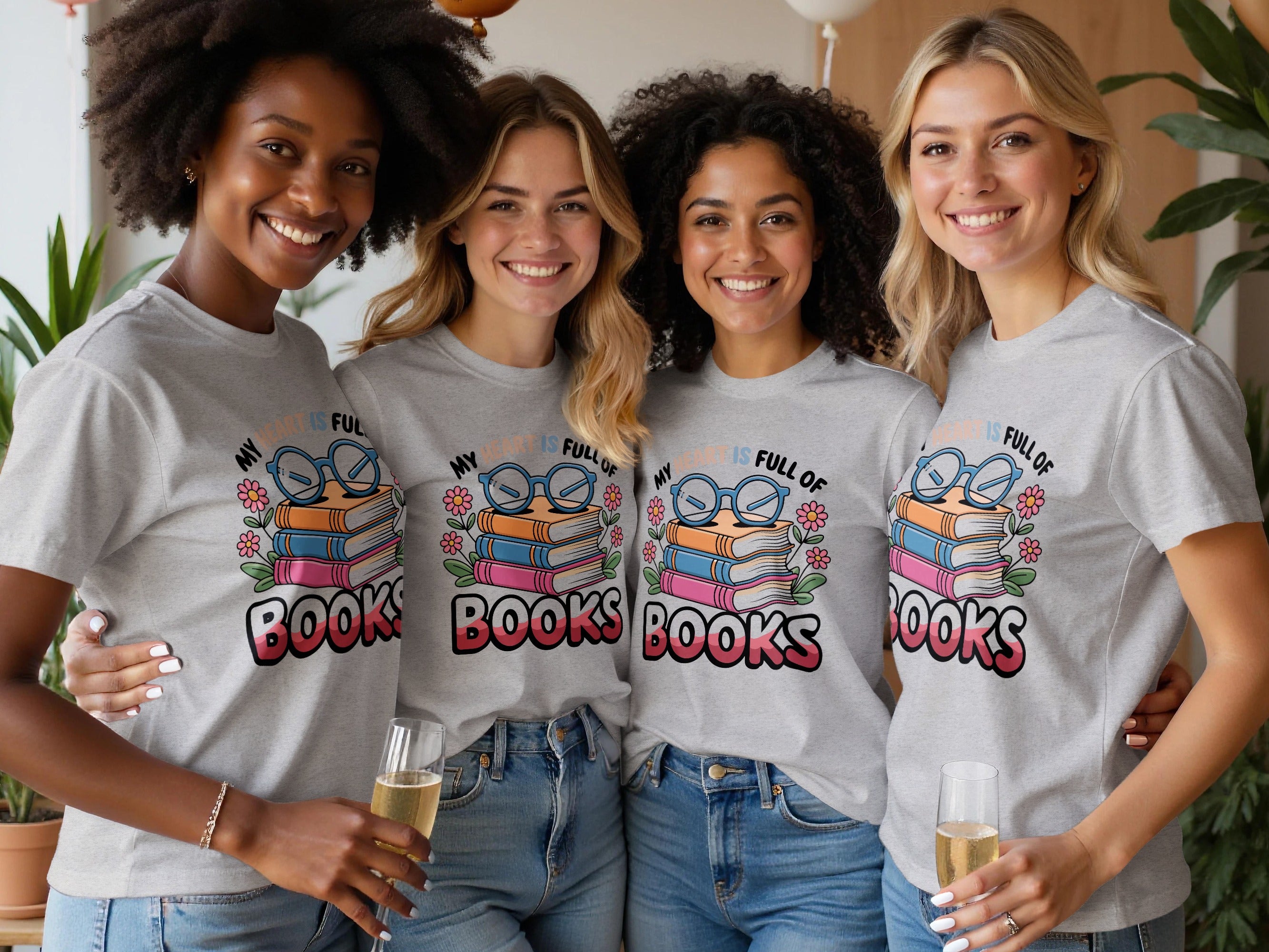 Four women in matching grey t-shirts with a "My heart is full of books" graphic.