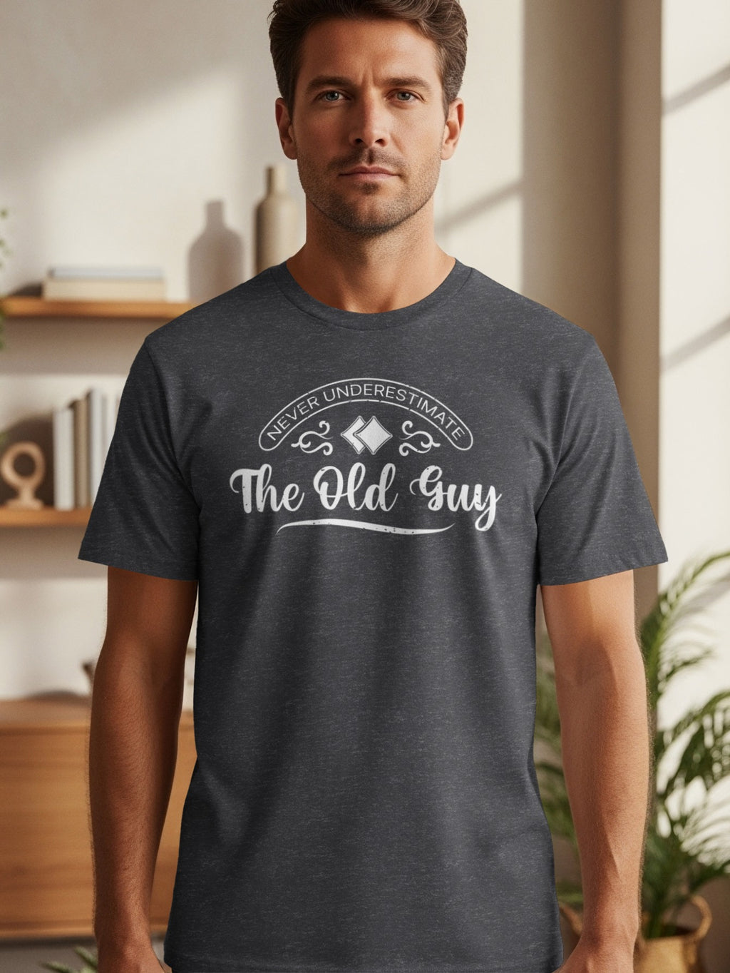 Dark grey t-shirt with white text "Never Underestimate The Old Guy".