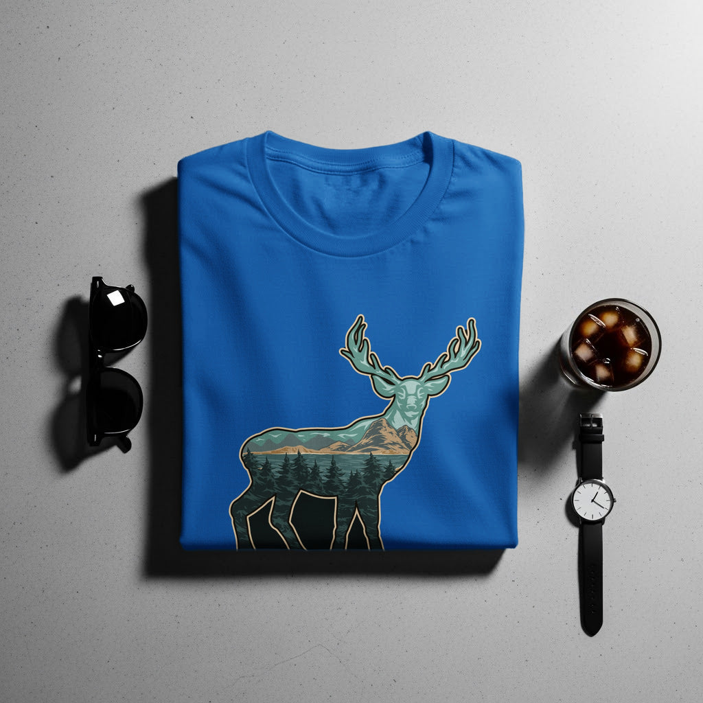 Blue t-shirt with a deer silhouette filled with a mountain and forest landscape.
