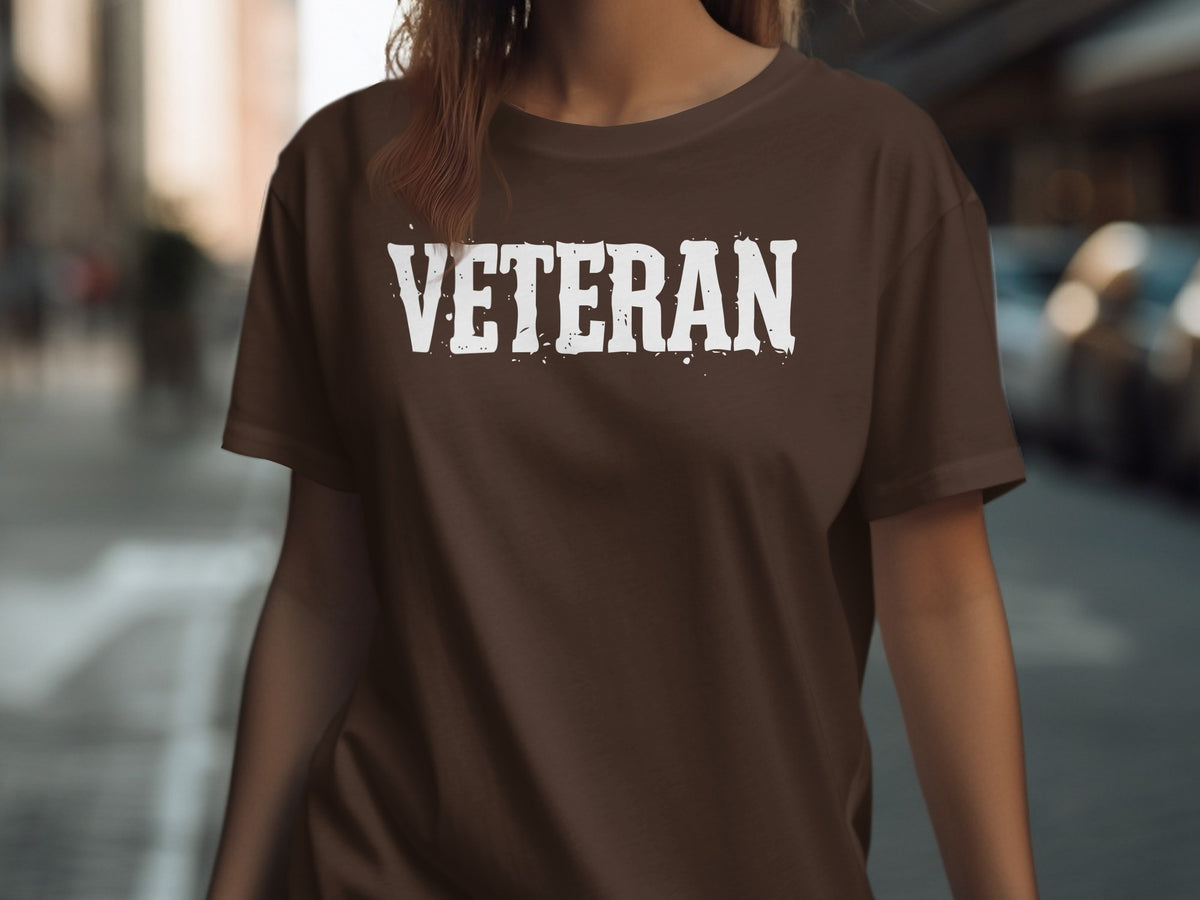 Brown t-shirt with distressed white "VETERAN" text graphic.